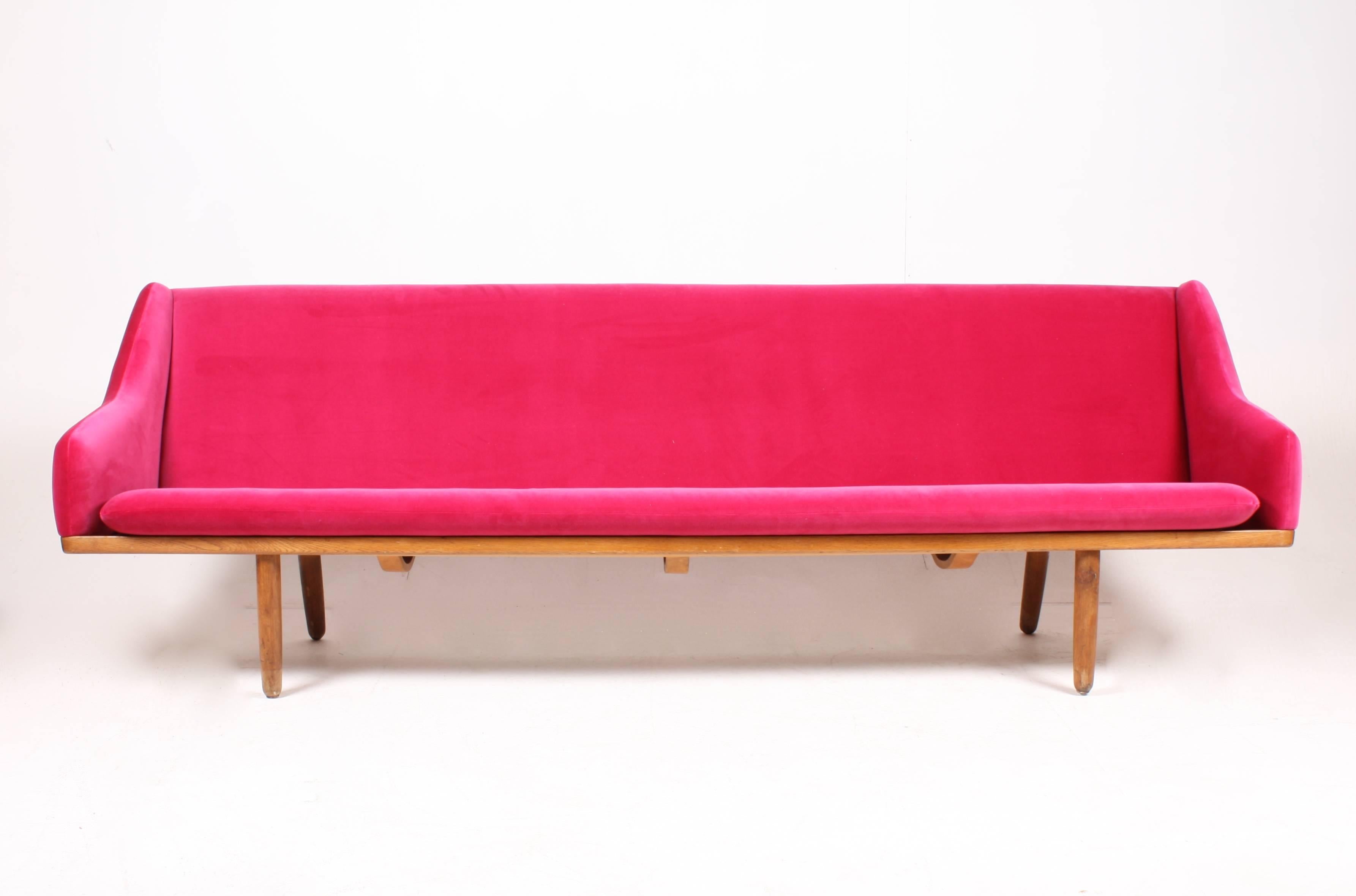 Freestanding four-seat sofa, model FR133 with oak frame. The frame is cleaned/waxed and the sofa is upholstered with new velvet fabric. Designed by Maa. Poul Volther for Frem Røjle cabinetmakers in the late 1950s. 
Great condition.