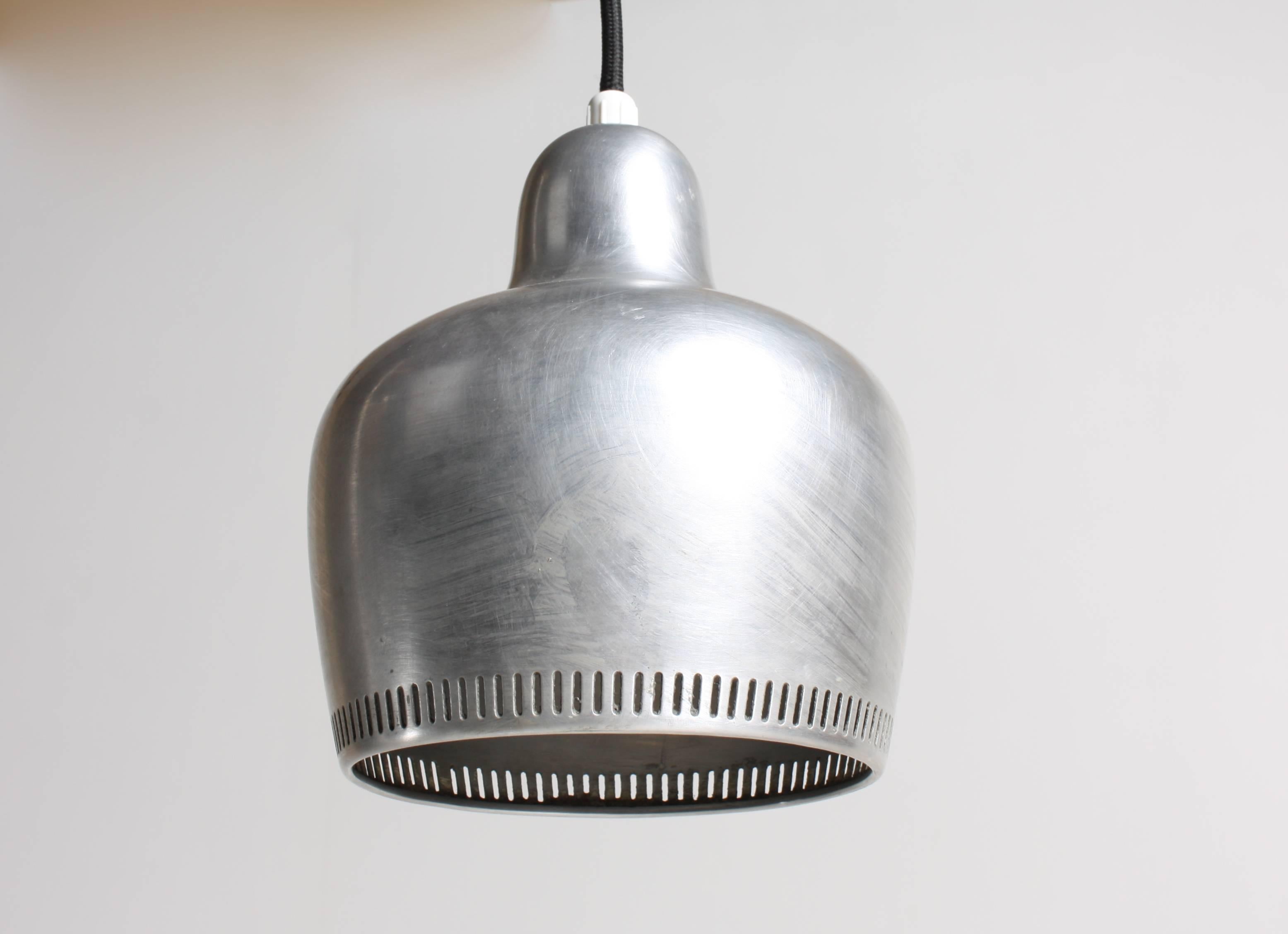 Group of four bell pendants in patinated metal designed by Alvar Aalto for Louis Poulsen in 1939. Great condition.