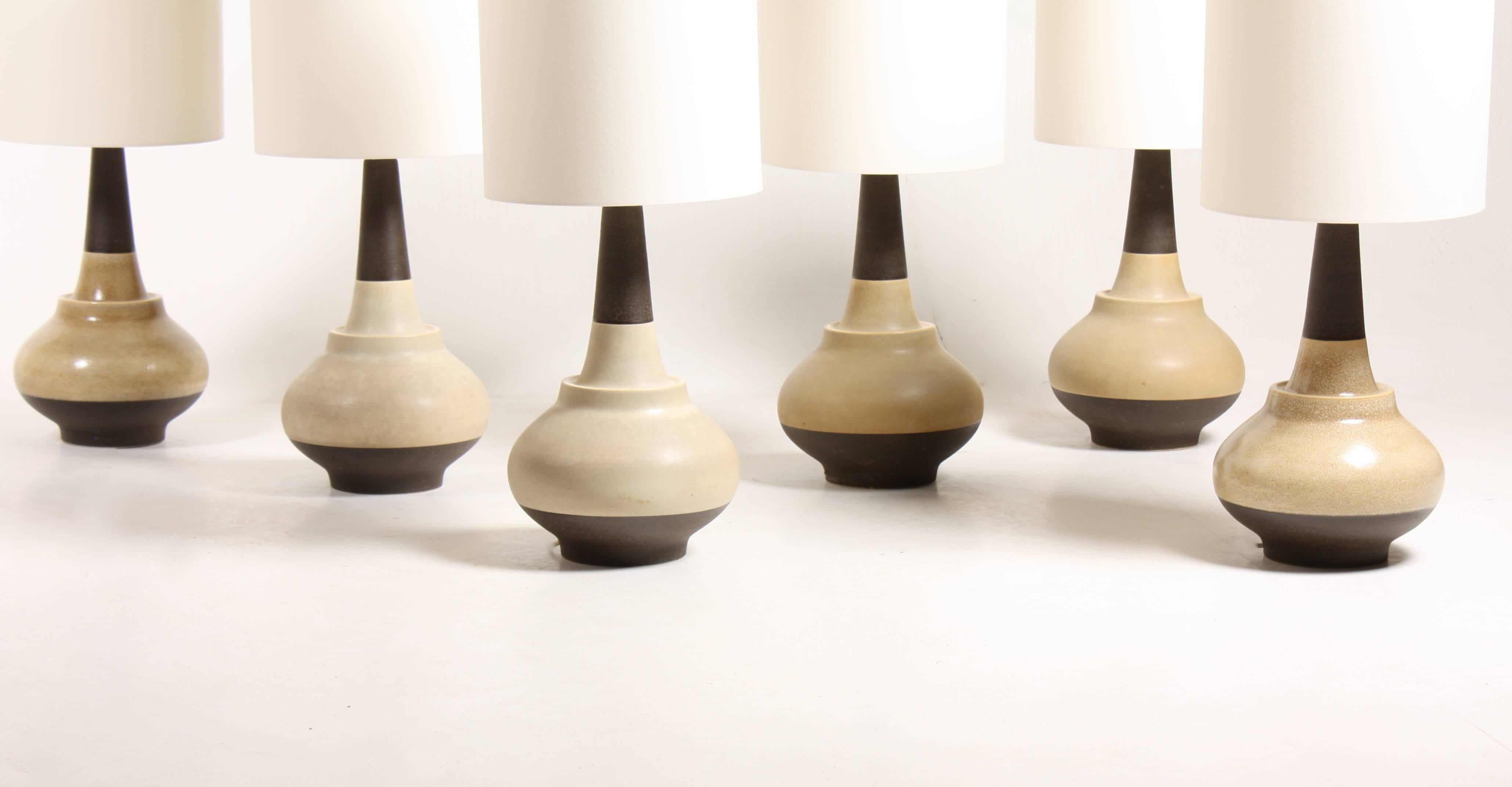 Set of six hand-thrown ceramic table lamps in various light colors. The set comes with new fabric lampshades.
Designed and made in Denmark for Søholm in the 1960s.


 