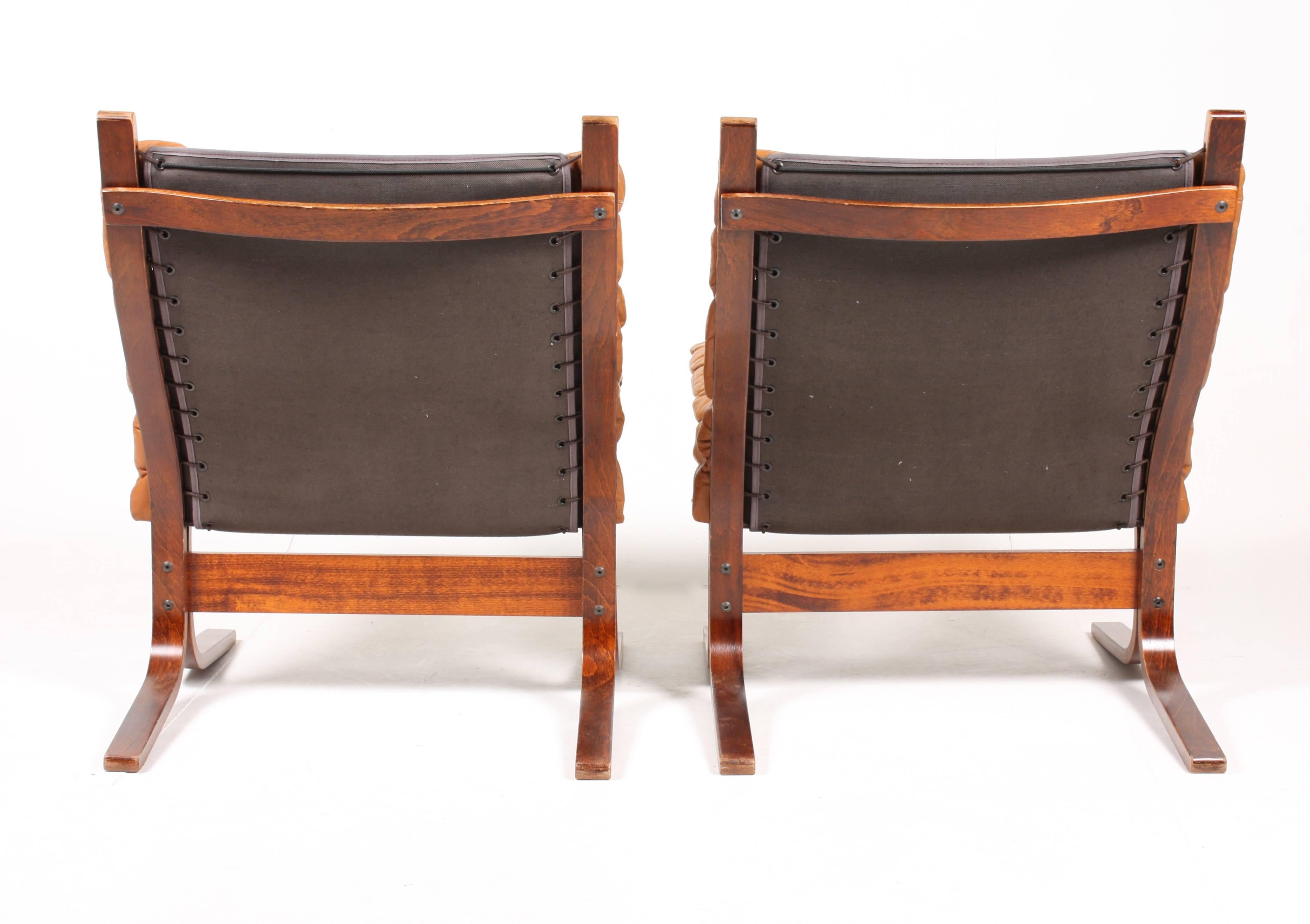 Pair of great looking lounge chairs in plywood and patinated leather designed by Ingmar Relling in 1965. Made in Norway. Great original condition.