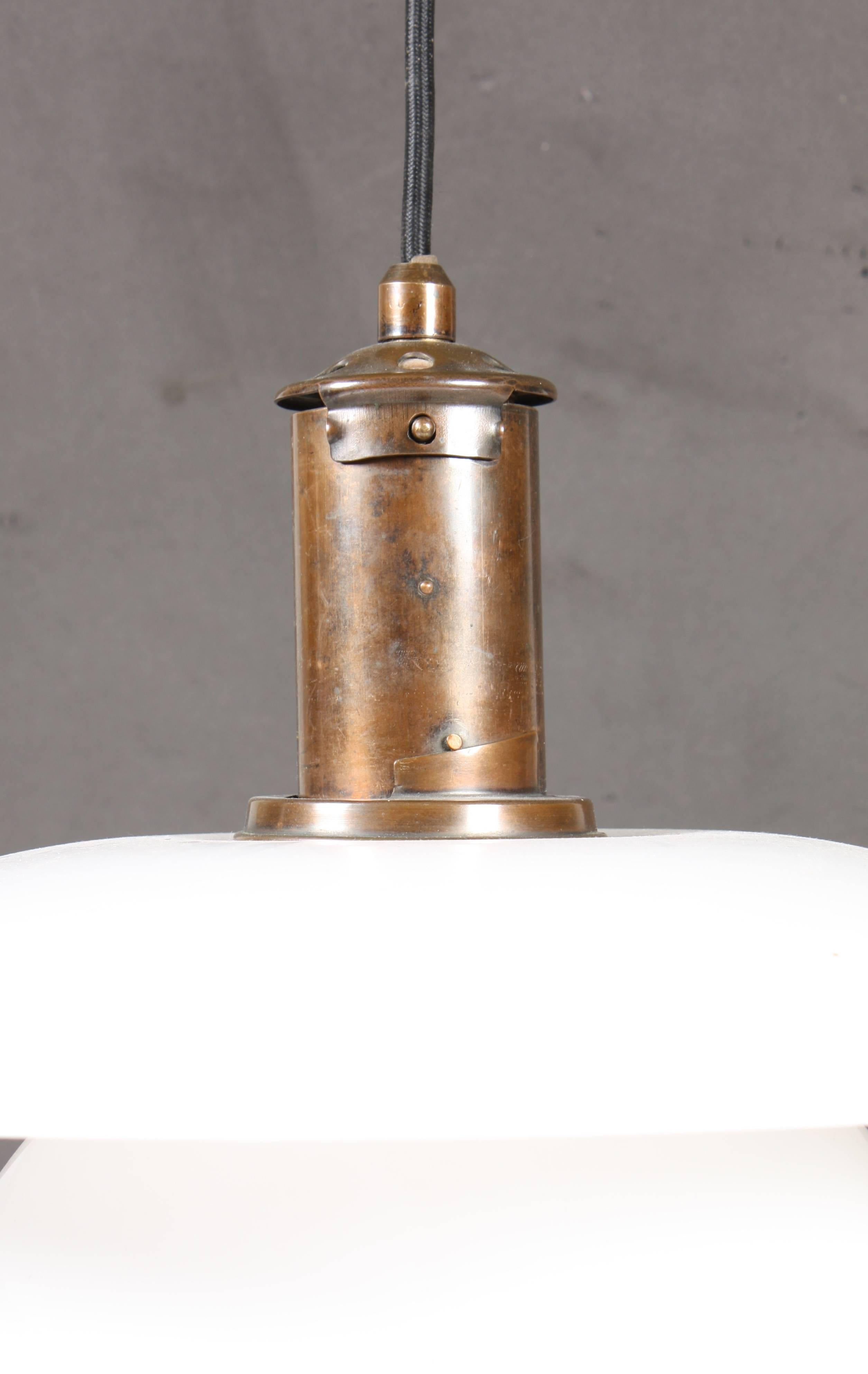 PH-4/4”. Pendant with browned brass socket house, later multi-layer opal glass shades. Manufactured by Louis Poulsen, 1930s.