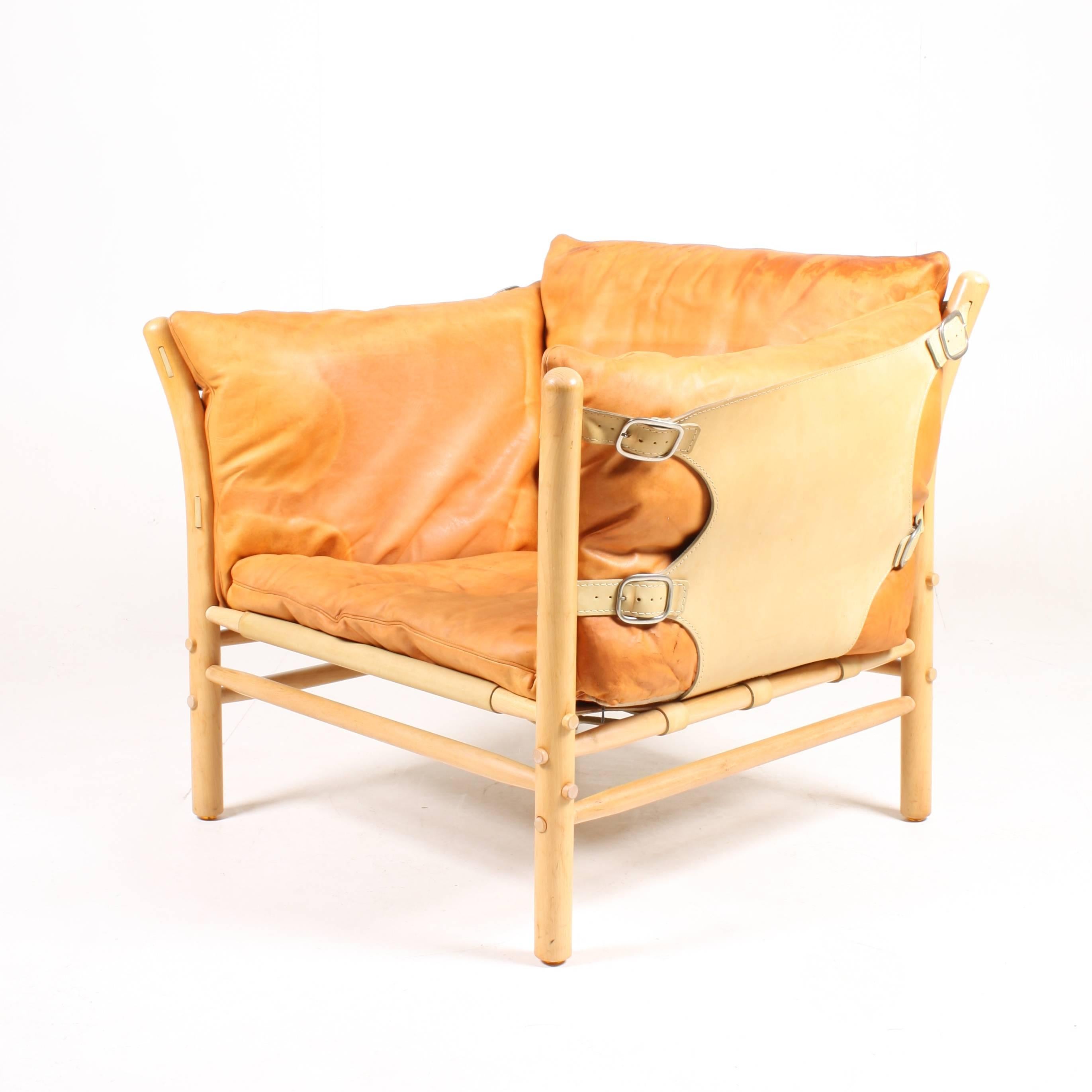 Lounge chair in beautiful patinated leather, wood frame and brass hardware. Model Ilona designed by Swedish architect Arne Norell for Norell Möbel AB in the 1960s.

The chair is cleaned, waxed and is from a non-smoker home. Very nice original