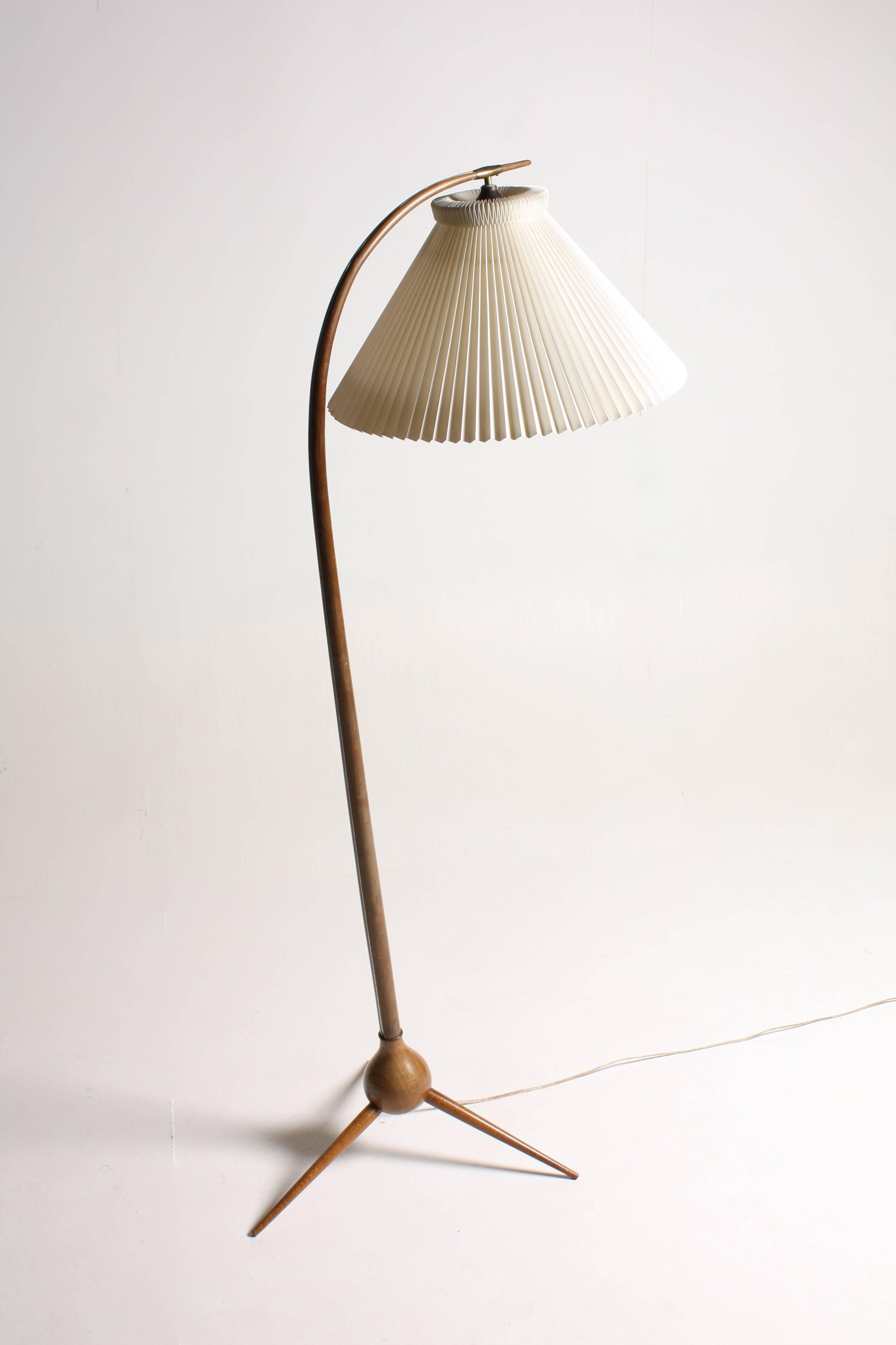 Elegant floor lamp in stained beech, comes with Le Klint lampshade. Designed by Severin Hansen and made by Haslev furniture in the 1950s. Made in Denmark.