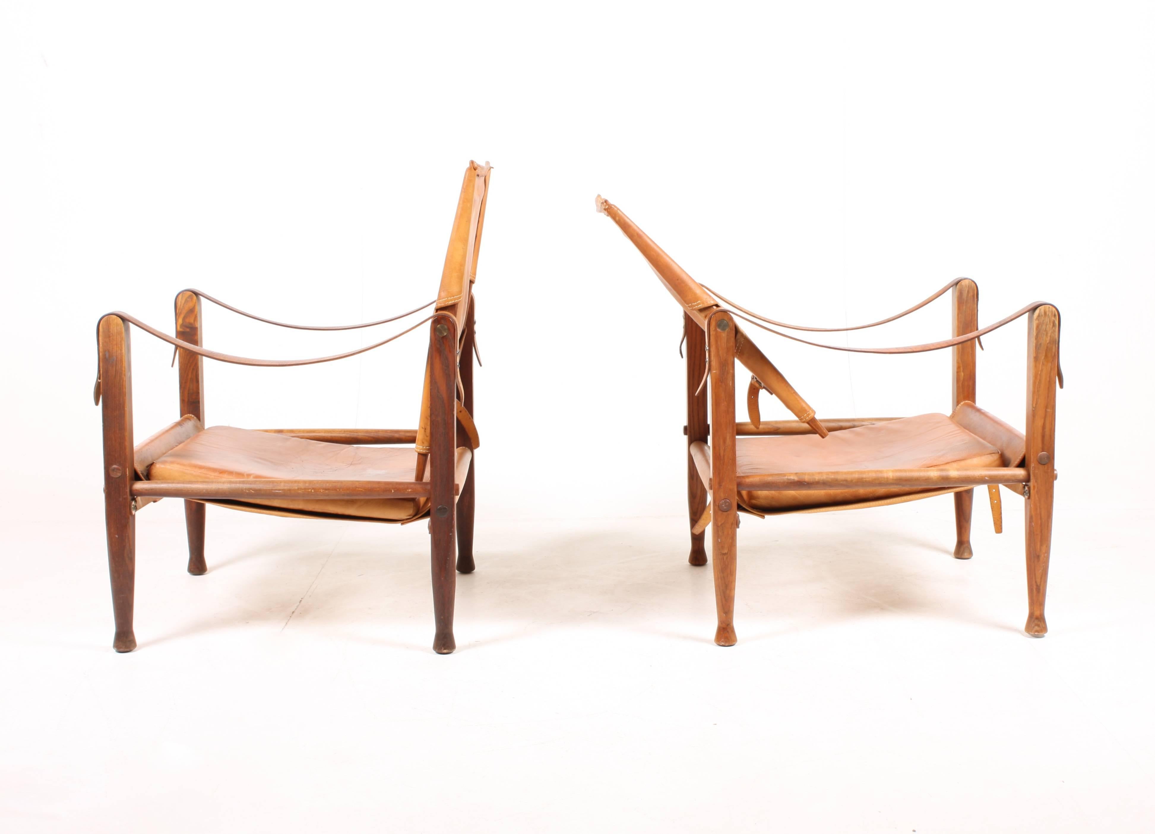 Pair of safari chairs in patinated leather. Designed by Maa. Kaare Klint for Rud Rasmussen Cabinetmakers of Denmark in 1933. Great original condition.