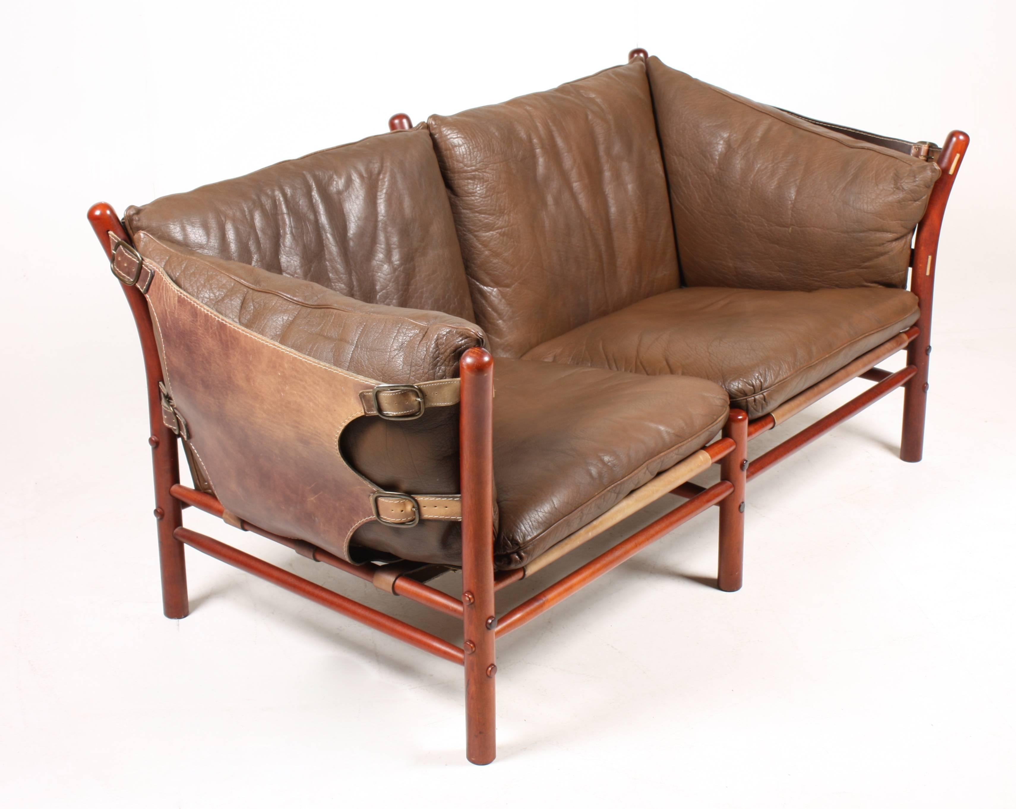 Two-seat sofa in beautiful patinated leather, wood frame and brass hardware. Model Ilona designed by Swedish architect Arne Norell for Norell Möbel AB in the 1960s. 

The sofa is cleaned, waxed and is from a non-smoker home. Very nice original