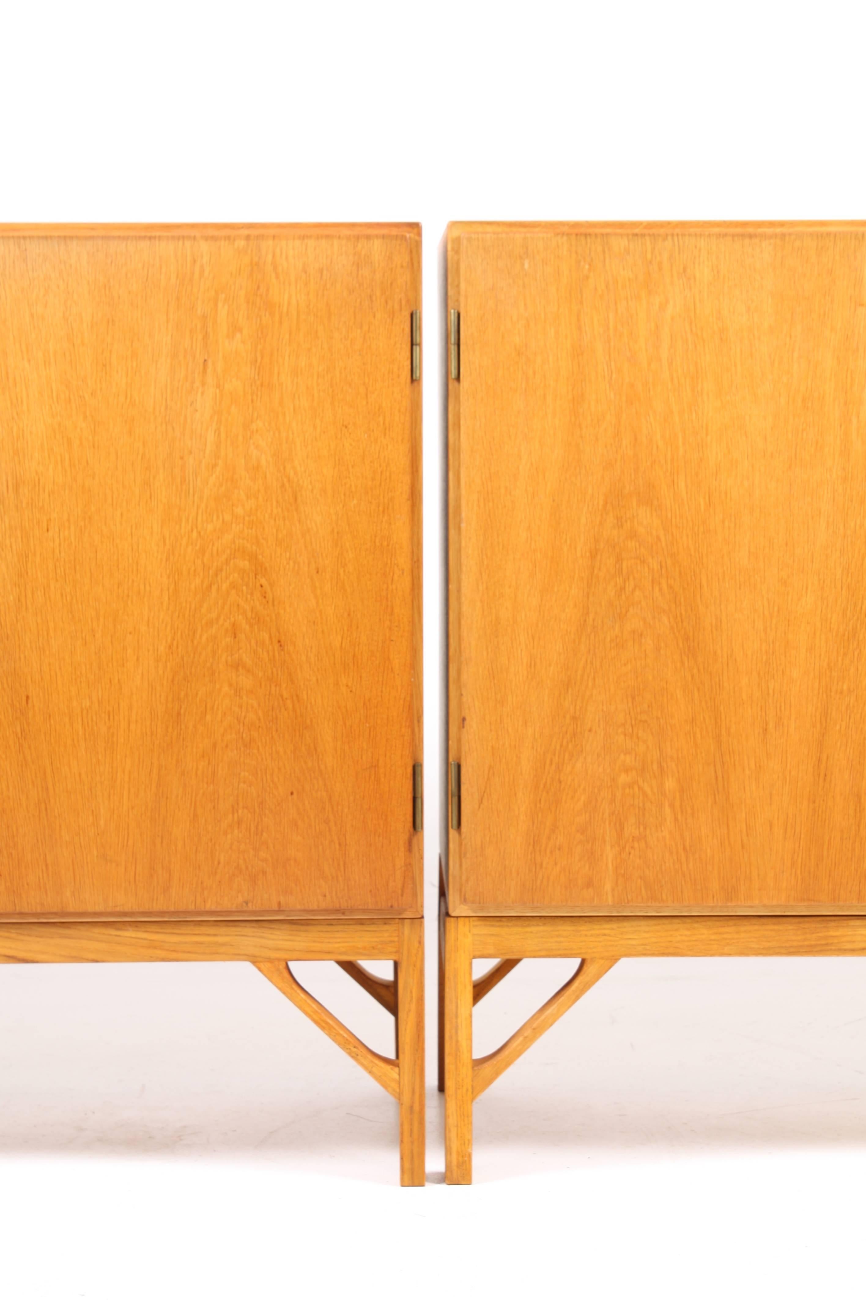 Pair of Pristine China, cabins in wax finished Scandinavian oak. Stunning brass hardware and maple interior. Designed by MAA. Børge Mogensen in 1958, this piece is made by CM Madsen cabinetmakers Denmark, in the 1960s. Great original condition.
 