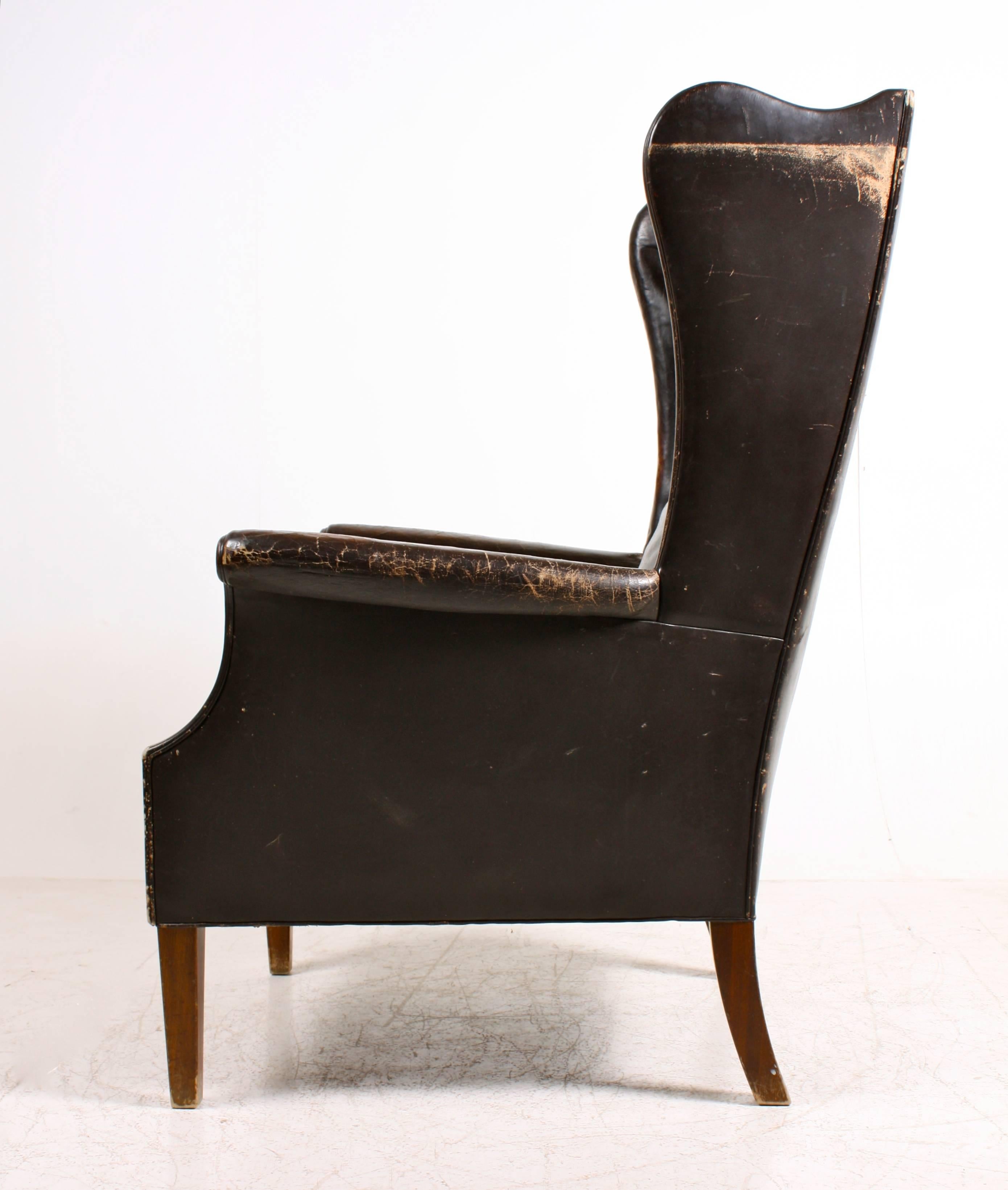 Decorative easy chair in very patinated leather, Danish, 1940s.