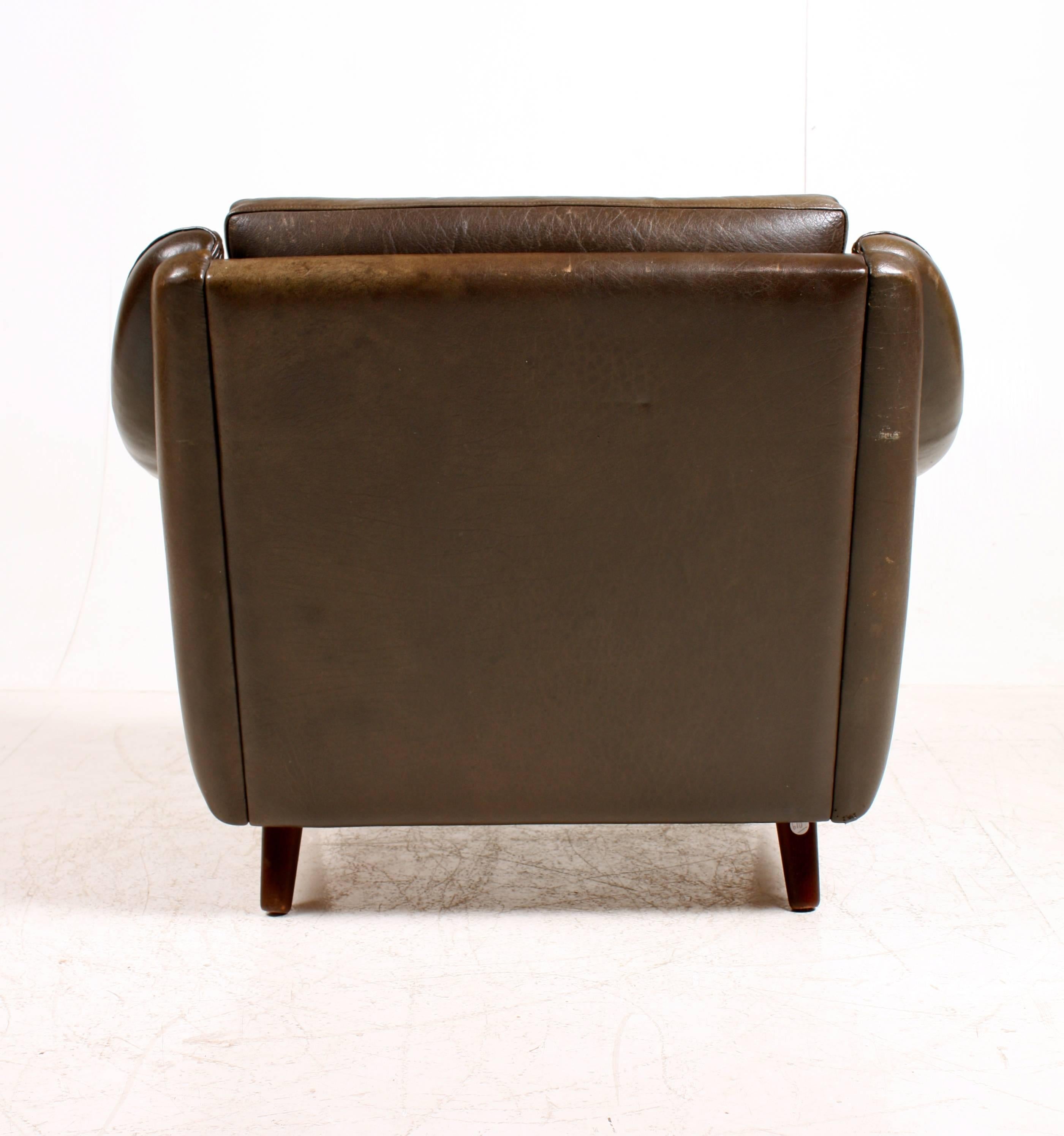 Great looking and very comfortable 1960's lounge chair in patinated leather. Designed by Maa. Aage Christensen and produced in Denmark by Erhadsen & Andersen. Original condition.