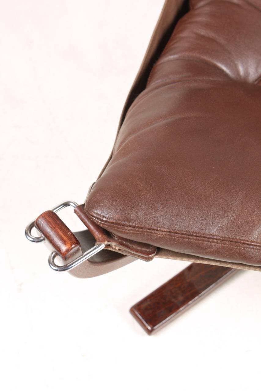 Original Falcon chair in red brown leather designed by Sigurd Resell, made by Vatne Norway in the 1970s.