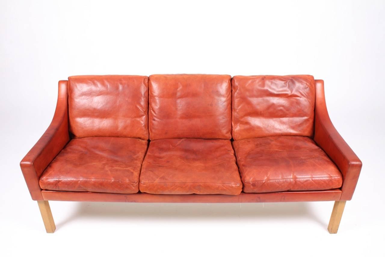 Three-seat sofa in patinated leather designed by Poul Volther for Erik Jørgensen in the 1960s. Made in Denmark. Good original condition.