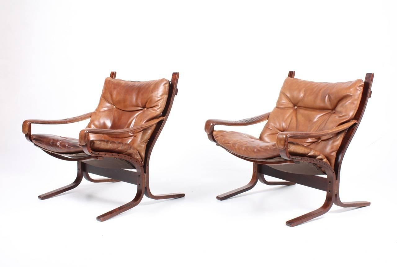 Pair of great looking lounge chairs in plywood and patinated leather designed by Ingmar Relling in 1965. Made in Norway. All original condition.