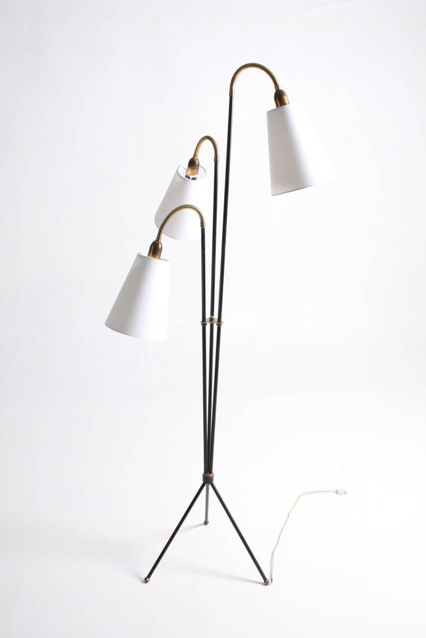 Great looking floor lamp in black painted metal and brass. Comes with new fabric shades. Designed and made by Holm Sorensen in the 1950s made in Denmark.