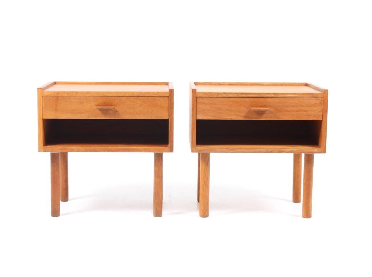 Pair of great looking nightstands in well patinated Scandinavian oak designed by Maa. Hans Wegner. Made by RY furniture Denmark in the 1960s. Very nice condition.