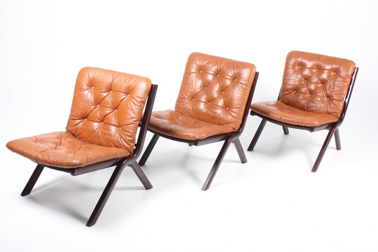 Set of three great looking lounge chairs in plywood and patinated leather designed and made in Denmark. Great original condition.

The lounge chairs are cleaned and waxed. Comes from a non-smoker home. Very nice original condition.