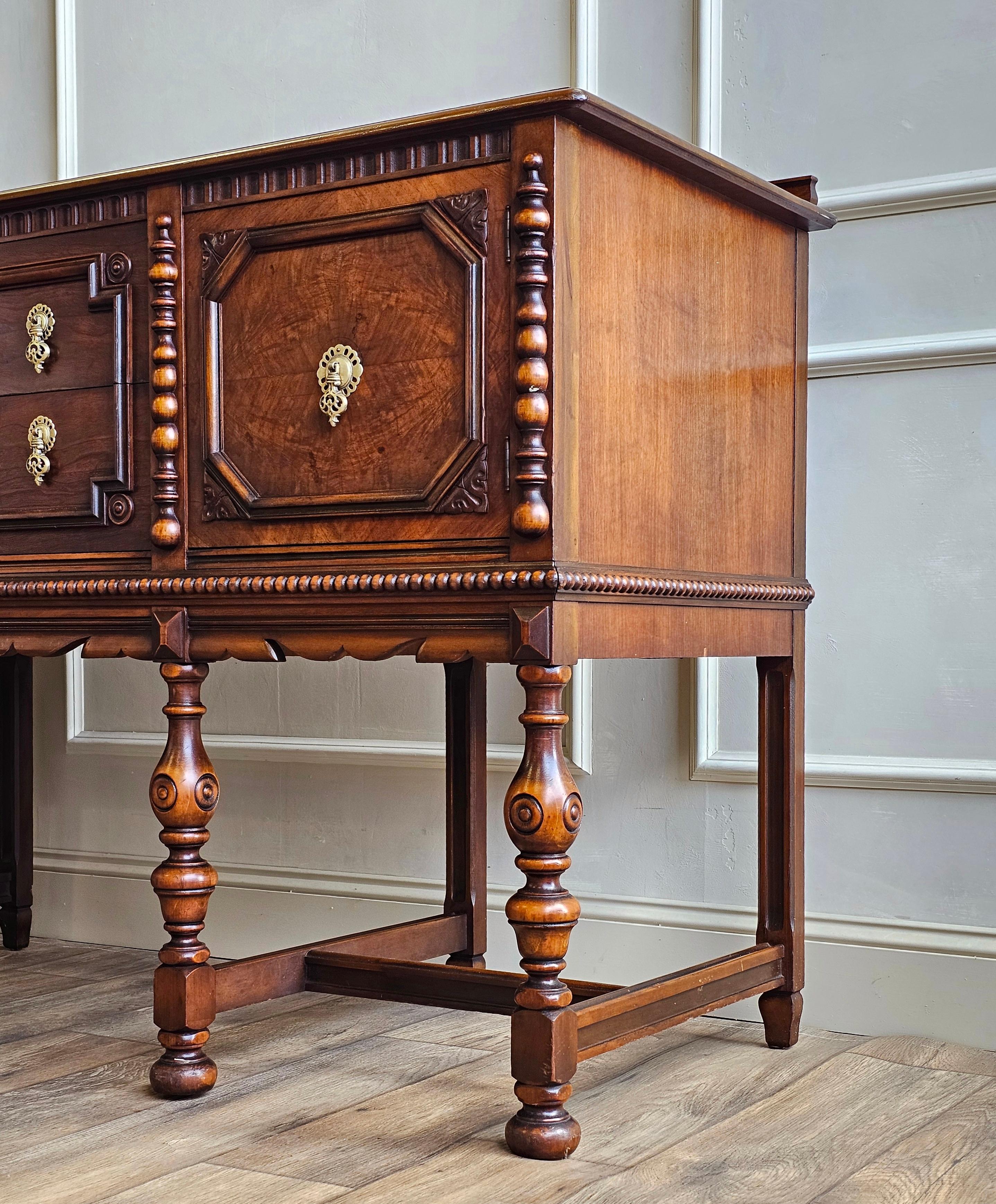 There’s a reason pieces like this continue to captivate collectors and decorators alike. Crafted by the esteemed Berkey & Gay Furniture Company, this Jacobean Revival buffet is a striking example of 1940s American furniture made in the spirit of Old