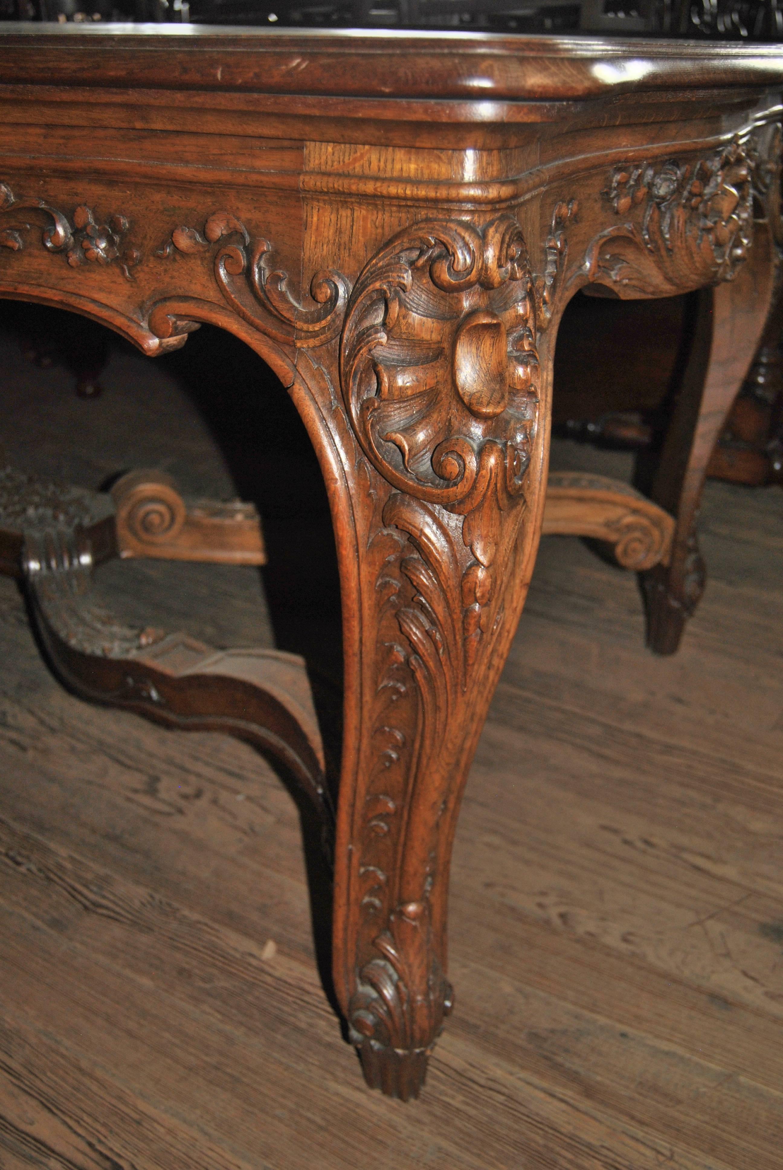 This is a fabulous quality, very highly carved table made in France, circa 1920. The table has extremely Fine quality carvings throughout. The sides and ends of the table are serpentine in shape with a double molded edge. The table has a beautiful
