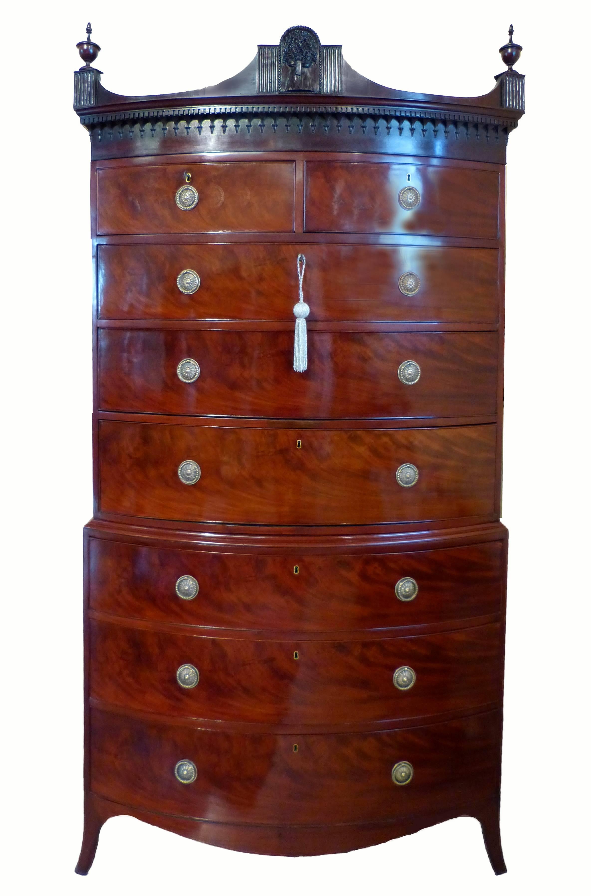 Fine and rare bow fronted chest on chest of the George III period in flame mahogany with the interior of the drawers of camphor wood and cedar. A Masterpiece of Georgian cabinet making of great proportions in the Hepplewhite style with out-splayed