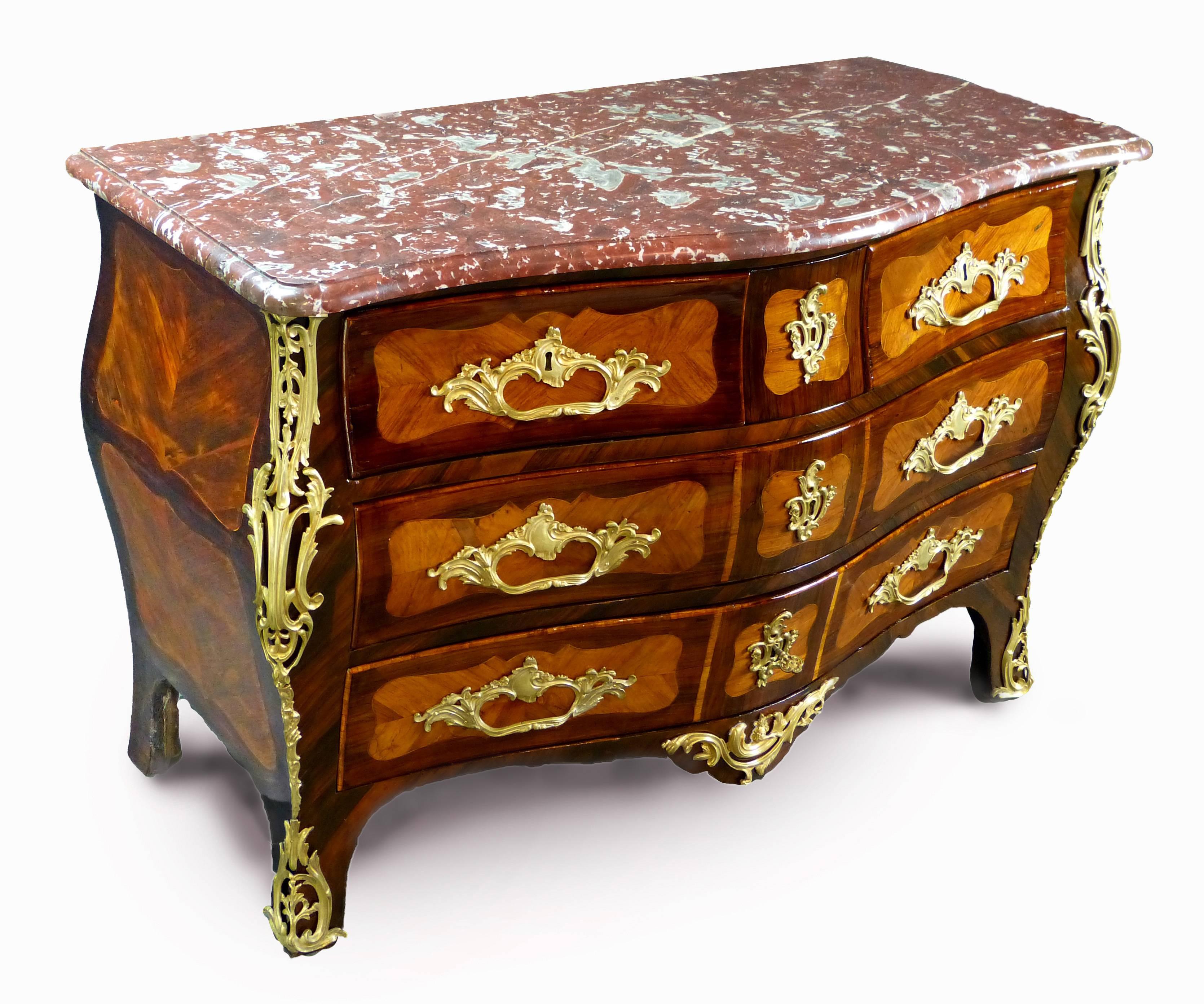 Outstanding Louis XV period mounted 'galbee' commode of cartouche shaped veneers of rosewood and kingwood with line inlays, bearing the stamp 