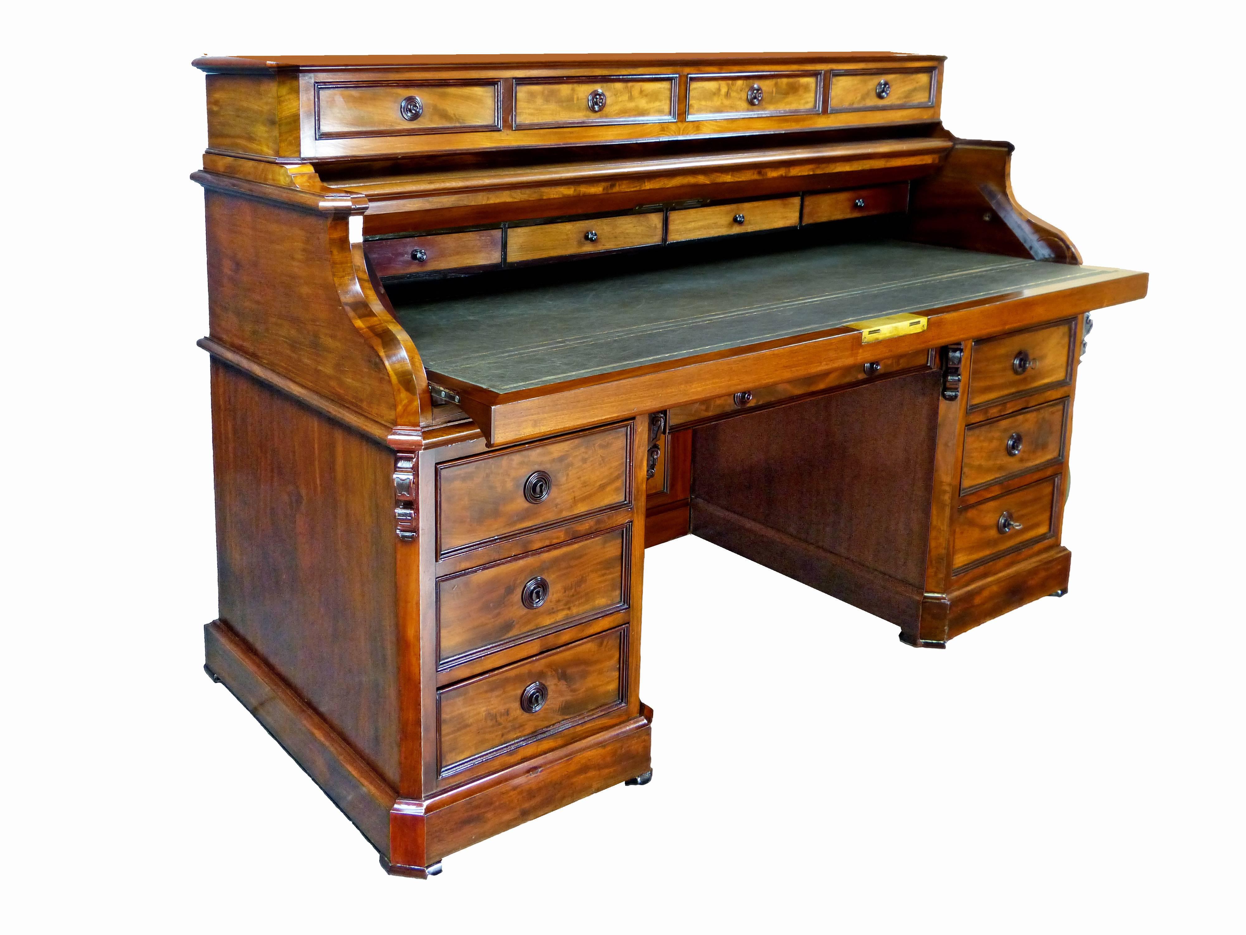 Important and exceptional quality large 4-sided French bureau of finely figured mahogany exterior and solid oak interior. Unique system of double action piano top that once the fall front is lowered the upper part also retreats inwards to reveal a