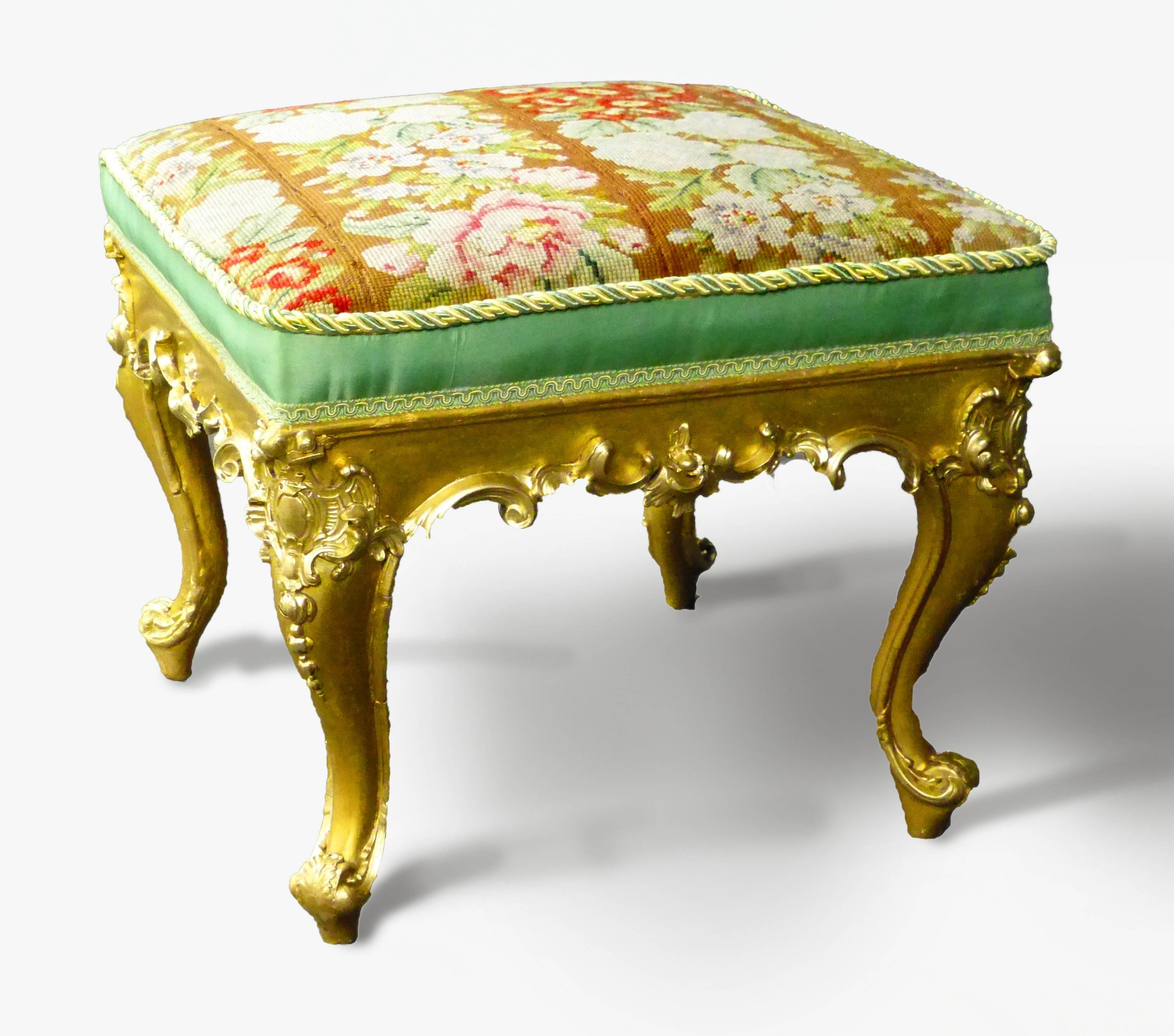 Attractive French stool in the Louis XV style with gilt over intricately carved wood with four cabriole legs upholstered in petit point over green satin. In excellent restored condition.

We specialise in shipping globally by Air.