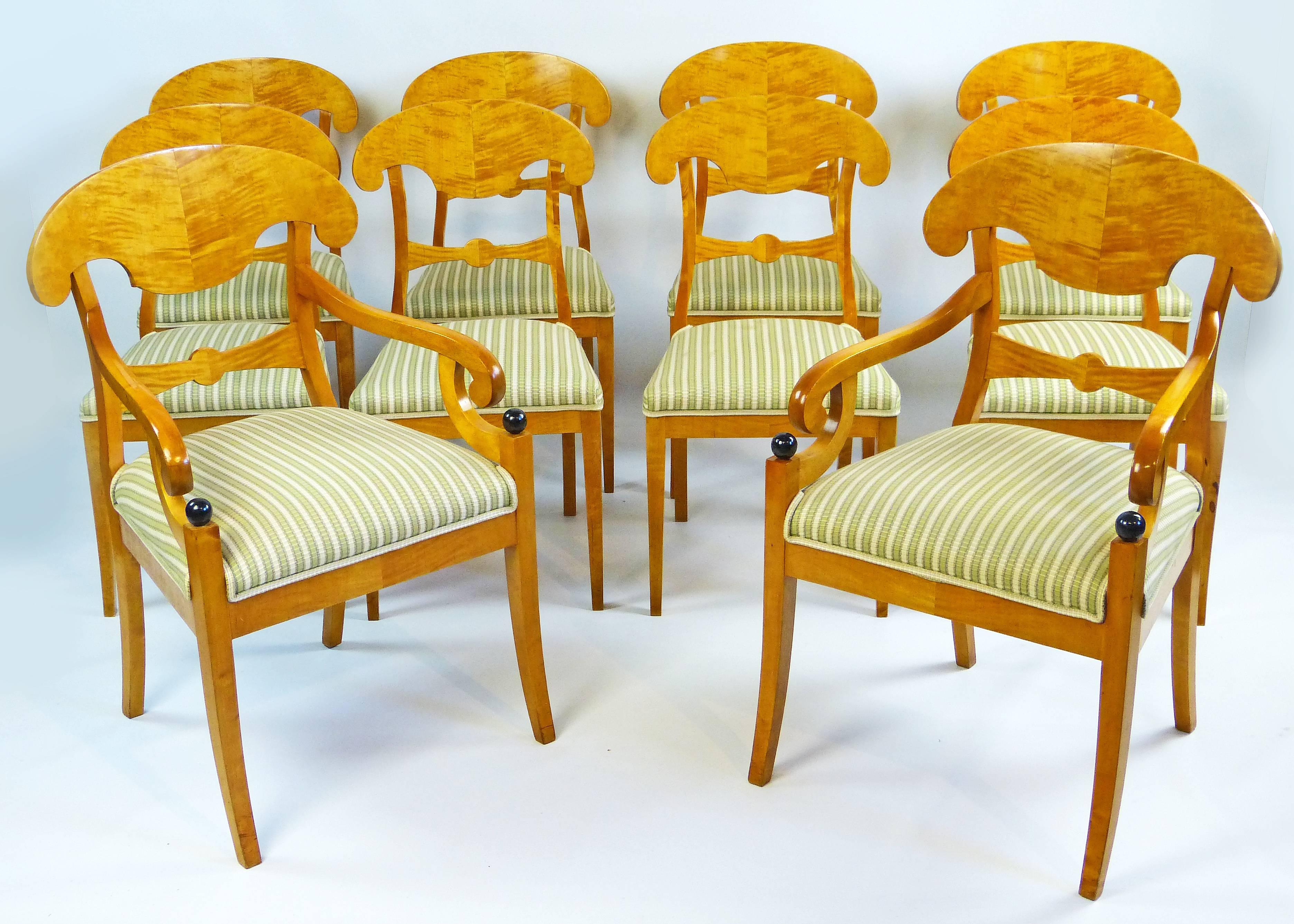 Outstanding and rare set of ten 19th century satin birch dining chairs of Swedish origin composed of eight chairs and two slightly larger armchairs for each end of the dining table. Truly outstanding color solid birchwood structure and satin