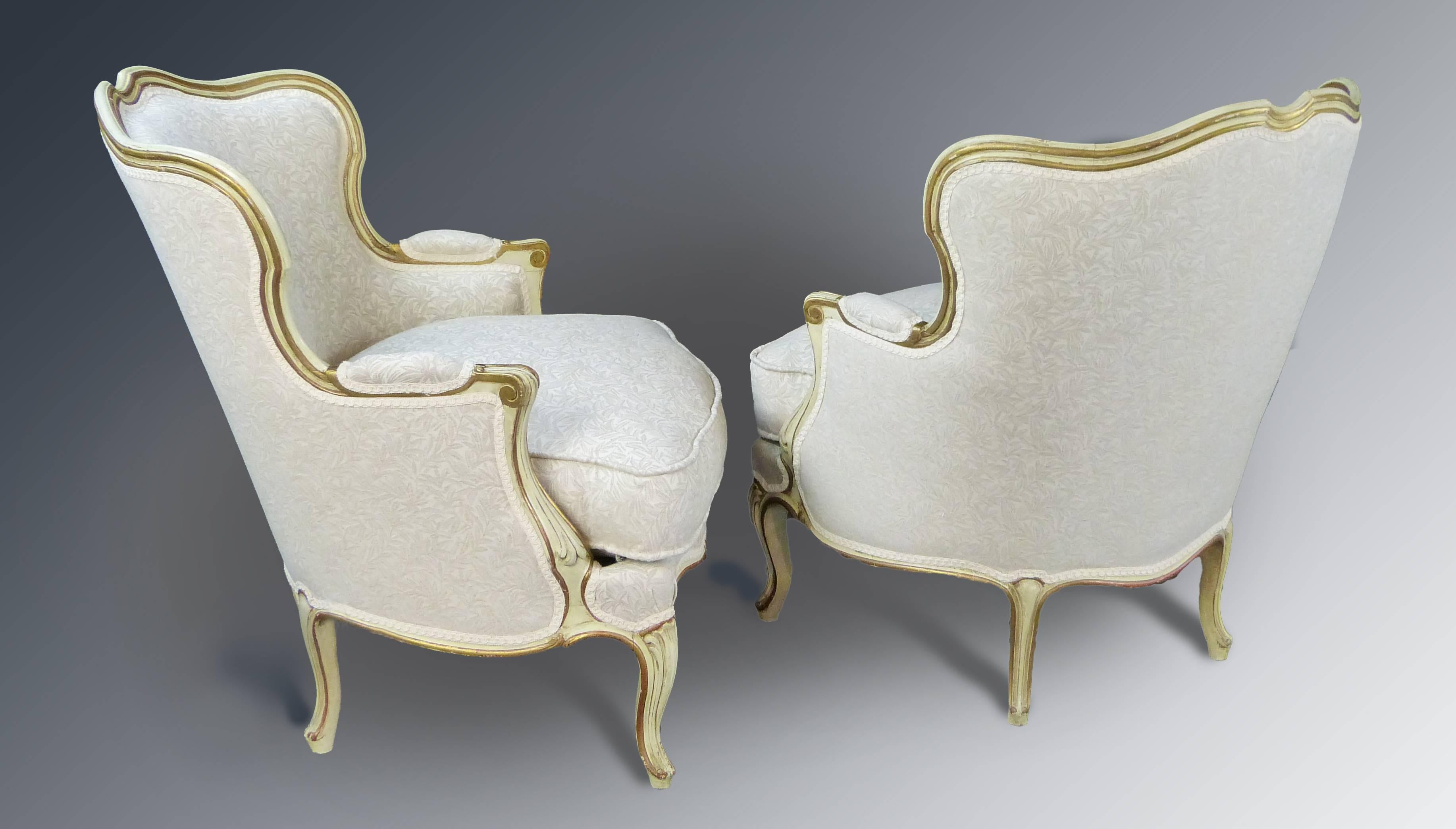 Attractive French Armchairs in the Louis XV style painted and slightly gilt having slight natural wear. Newly upholstered and in excellent condition, can be reupholstered according to customer's taste. Extremely comfortable medium sized armchairs.