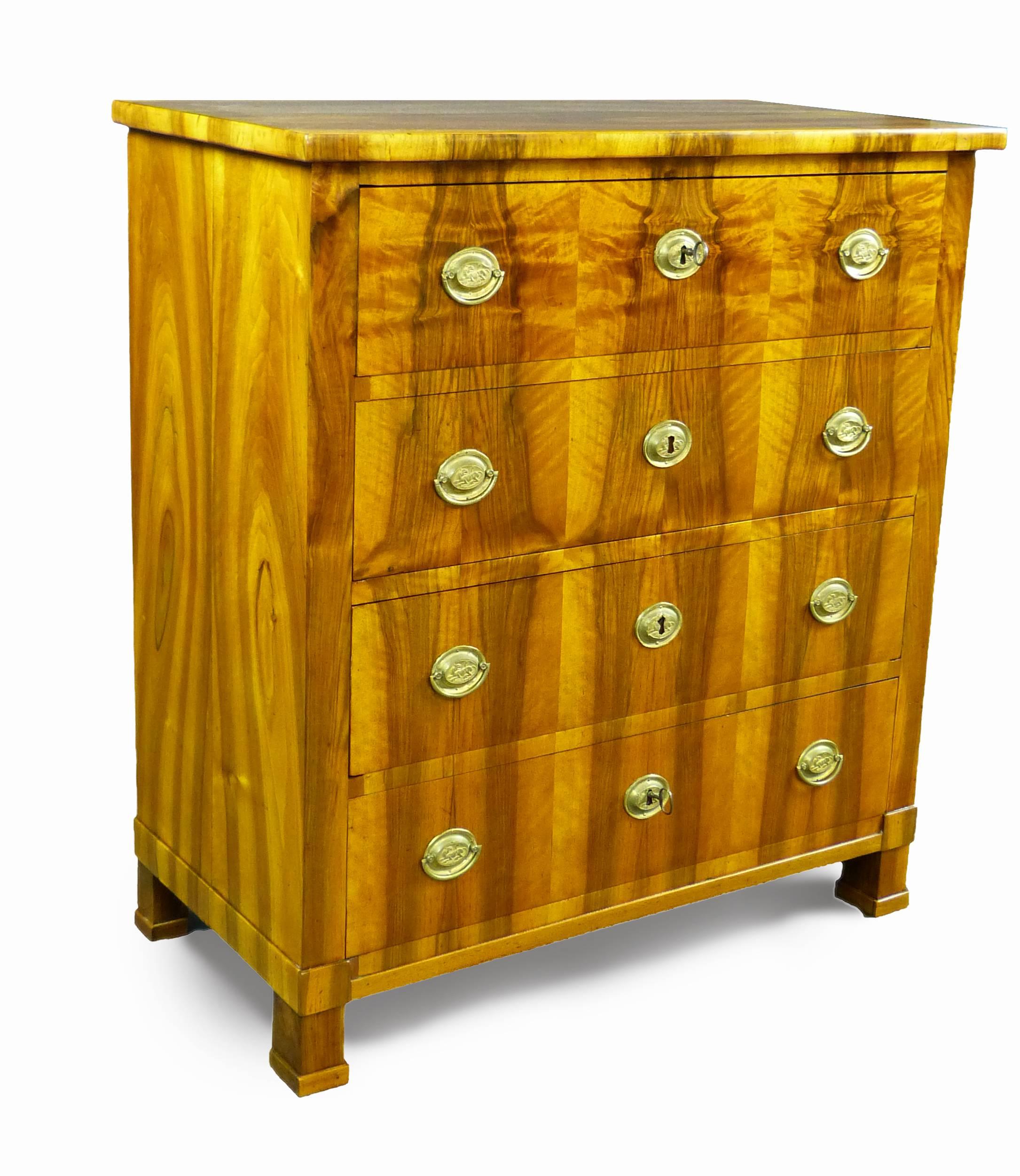 Early 19th century Biedermeier commode/chest of drawers with rare and outstandingly matched olive wood veneers on all four sides, definitely the work of a master craftsman. It is of Swedish origin with four drawers that bear oval shaped pressed