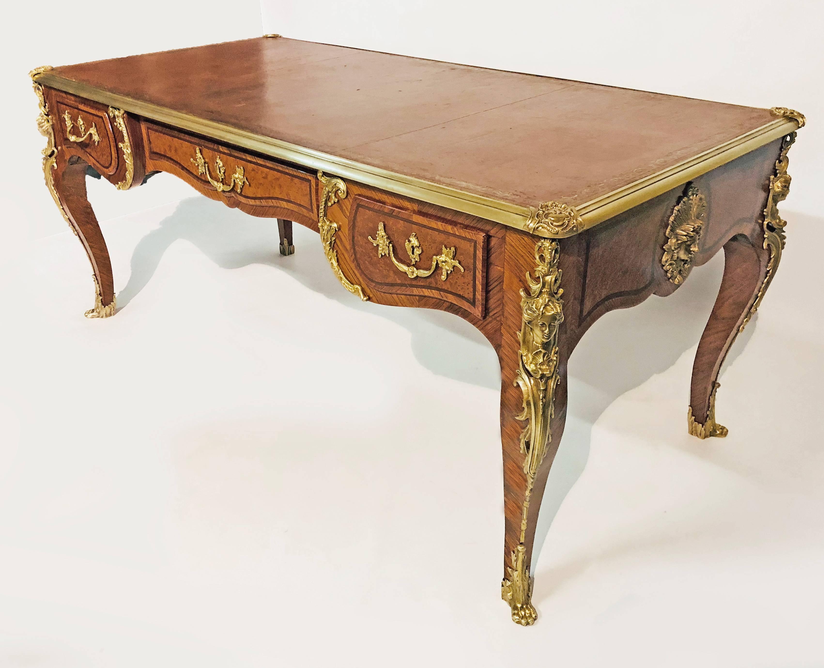 A magnificent French Louis XV style Bureau Plat dating to the end of the 19th century, with outstanding  marquetry of exotic woods such as kingwood, amboyna and mahogany over a structure of solid oak. The masterful marquetry is applied in