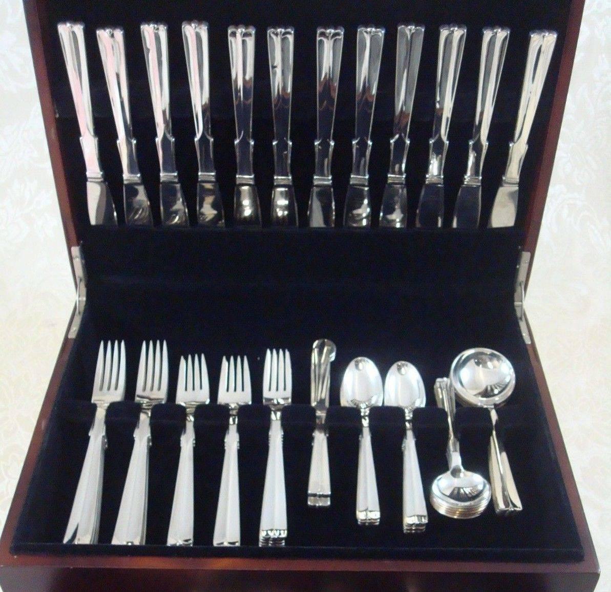 Baronet aka Arvesolv #7 by hans hansen sterling silver flatware set of 96 pieces. This pattern has a simple design with fine lines and bead-like detail on the tip of the handle. This set includes:

12 knives, long handle, 8 3/4