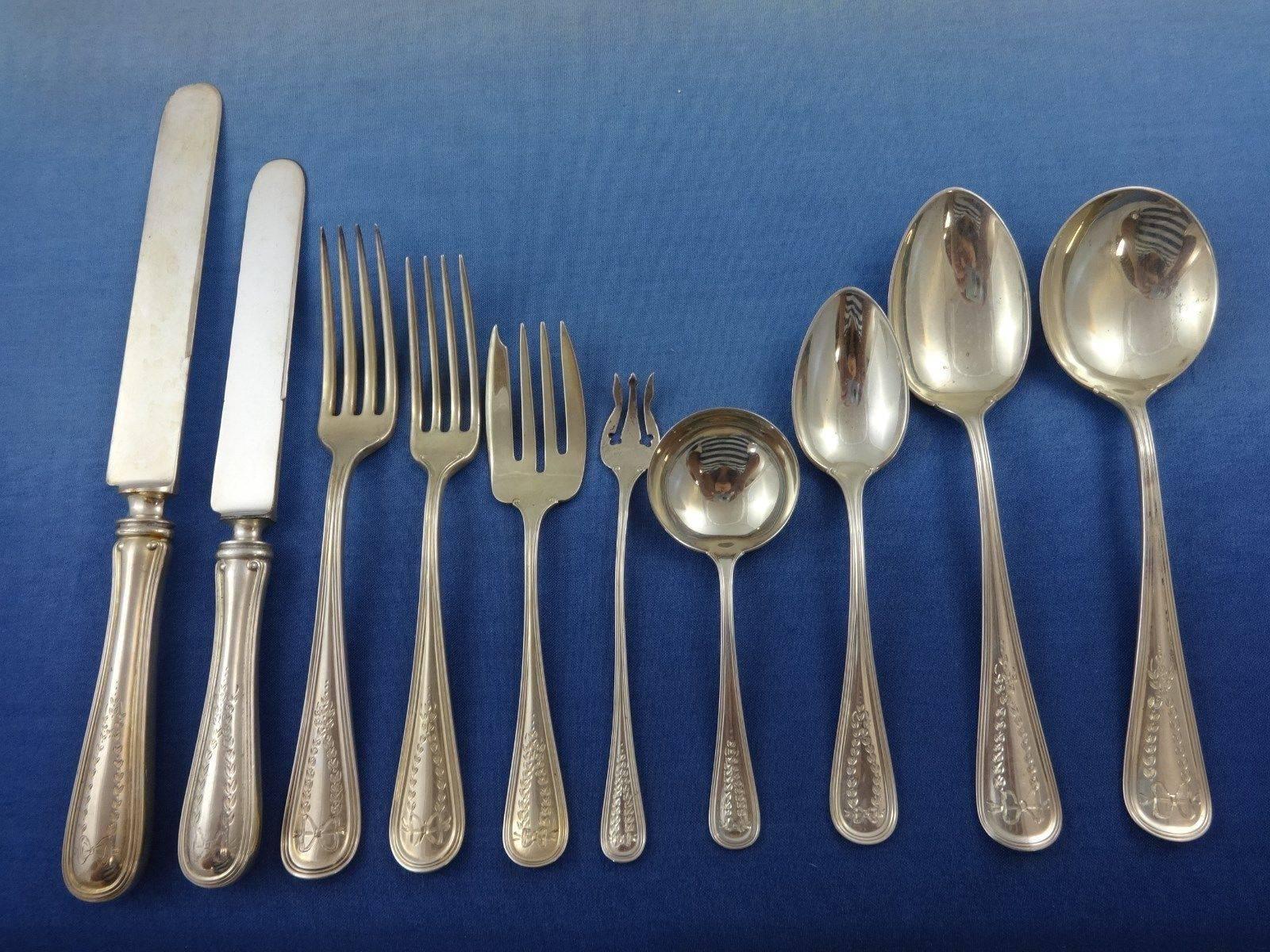 Exceptional Commonwealth Engraved by Watson sterling silver dinner flatware set of 132 pieces. This pattern features an lovely engraved design of a bow and wreath. This set includes:

12 dinner size knives, 9 7/8