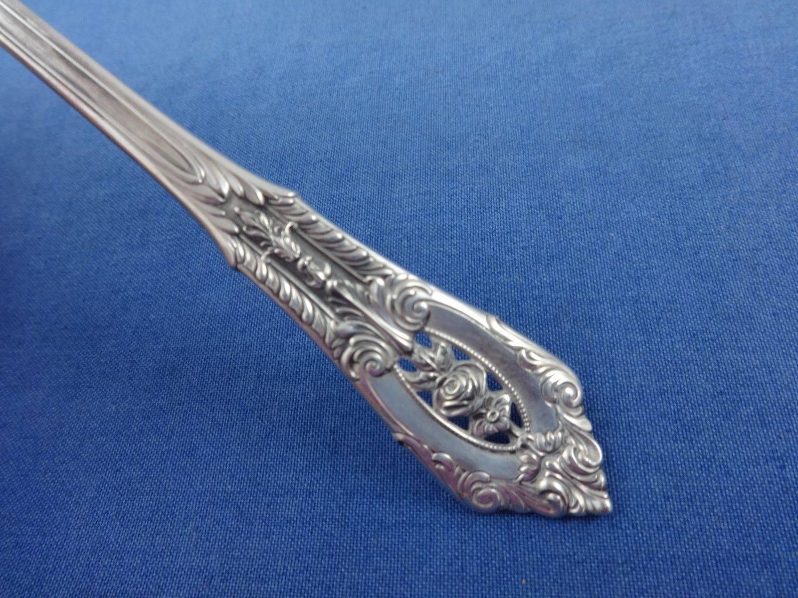 Intricate piercings and brilliant craftsmanship define this Rose point sterling silver flatware, sure to become a treasured family heirloom. The design of silver lace and a floating rose amidst deep scrolls and shimmering dew drops will grace your