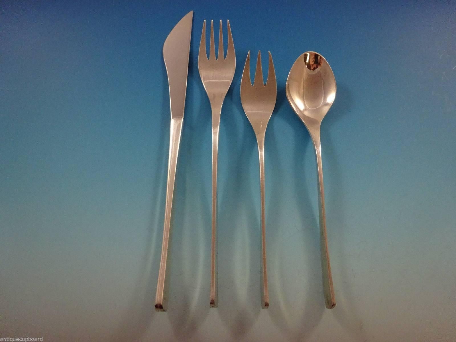 A set of vintage International sterling flatware in the pattern Vision designed by Ronald Hayes Pearson patented in 1961. This discontinued pattern features clean, modernism inspired lines and is featured in the book 