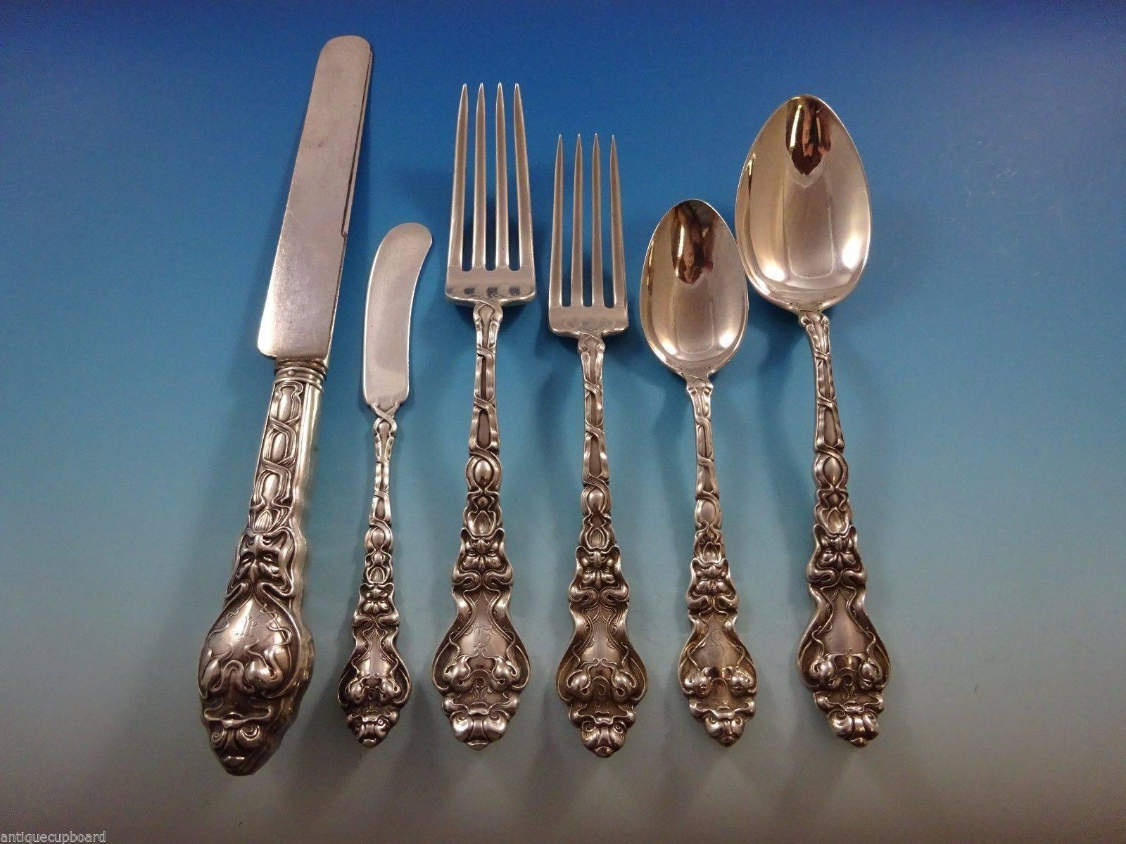 Exceptional Figural Art Nouveau Douvaine by Unger sterling silver flatware dinner size set of 61 pieces. This pattern features a stylized dolphin and the face of the North Wind. This set includes:

Eight dinner knives, 9 1/2