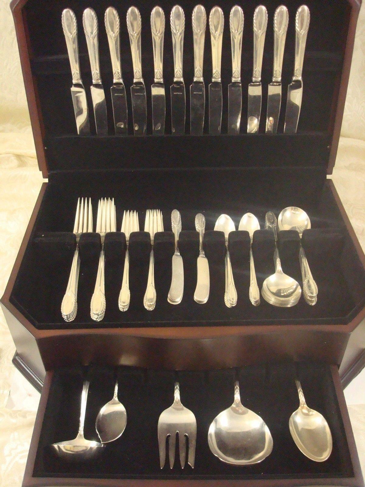 Trousseau by International sterling silver flatware set dinner size of 77 pieces. This set includes:

12 dinner knives, 9 1/2