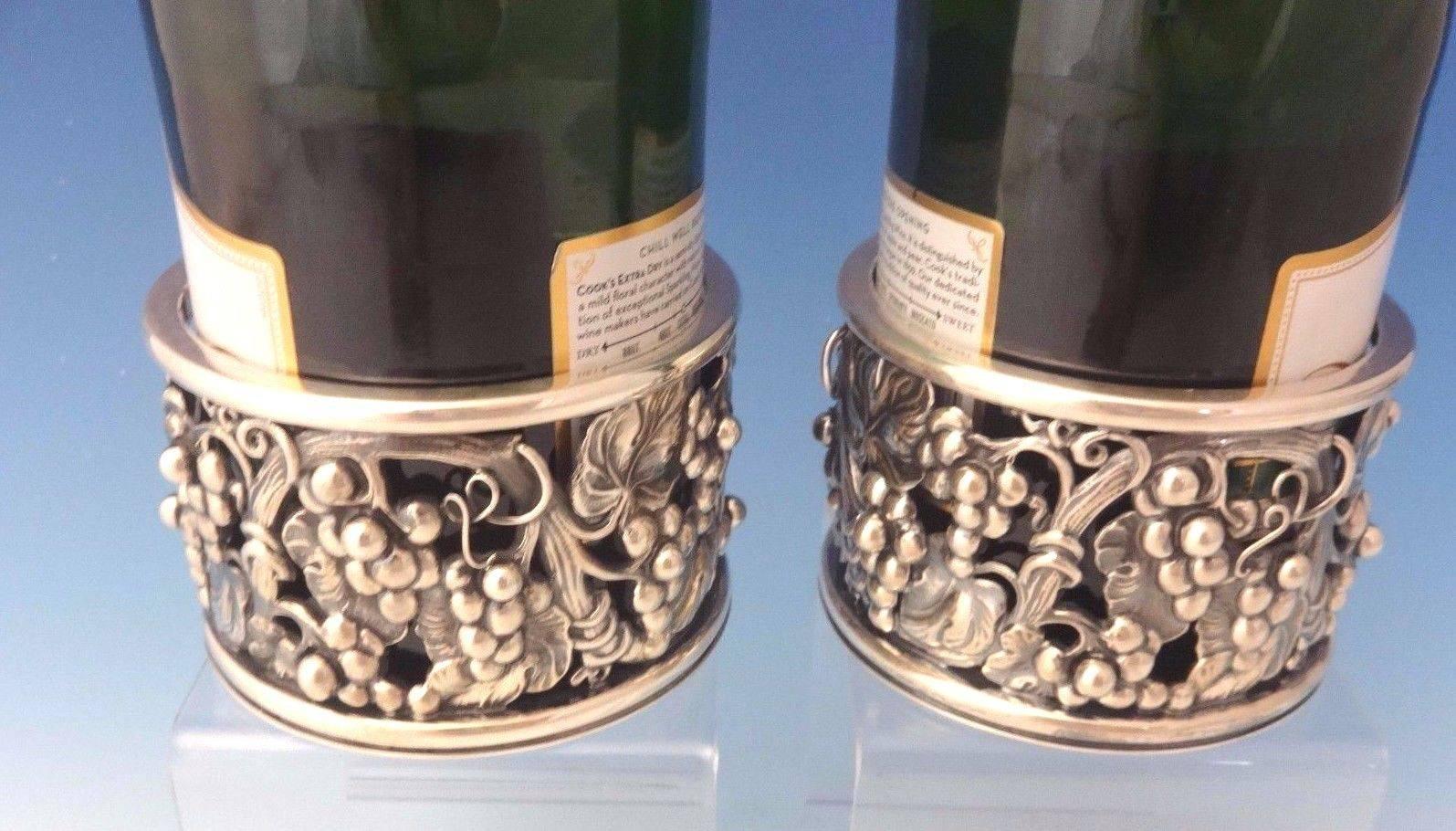 Evald Nielsen:

This pair of sterling wine coasters was made by Evald Nielsen with a beautiful pierced grape motif. The pair dates from the 1970s. They measure 2 3/4
