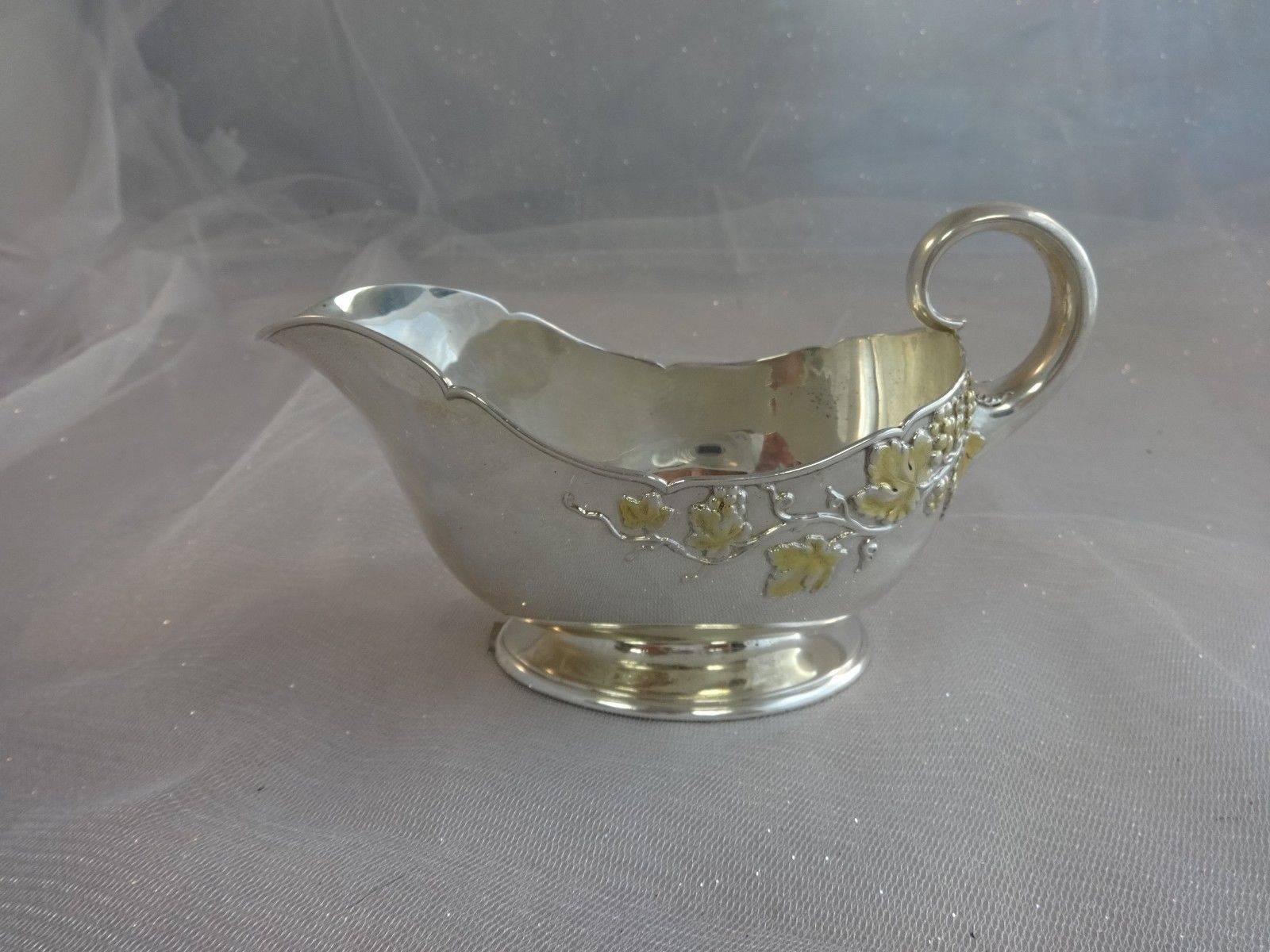 Mixed metals by Tiffany & Co.

Mixed metals by Tiffany & Co. sterling gravy boat with applied gilt grapes and leaves on vines. The piece is stamped with a 