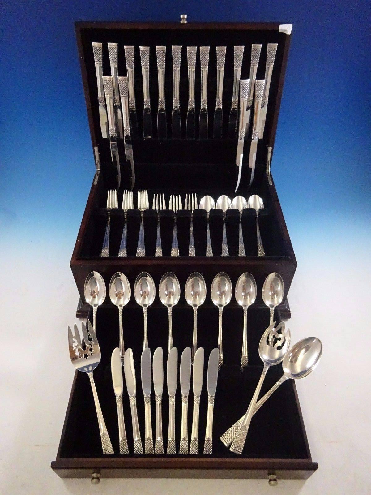 Columbine by Lunt sterling silver flatware set, 59 pieces. This scarce pattern features a unique woven, basket weave style design with floral detailing. This set includes:

Eight knives, 9