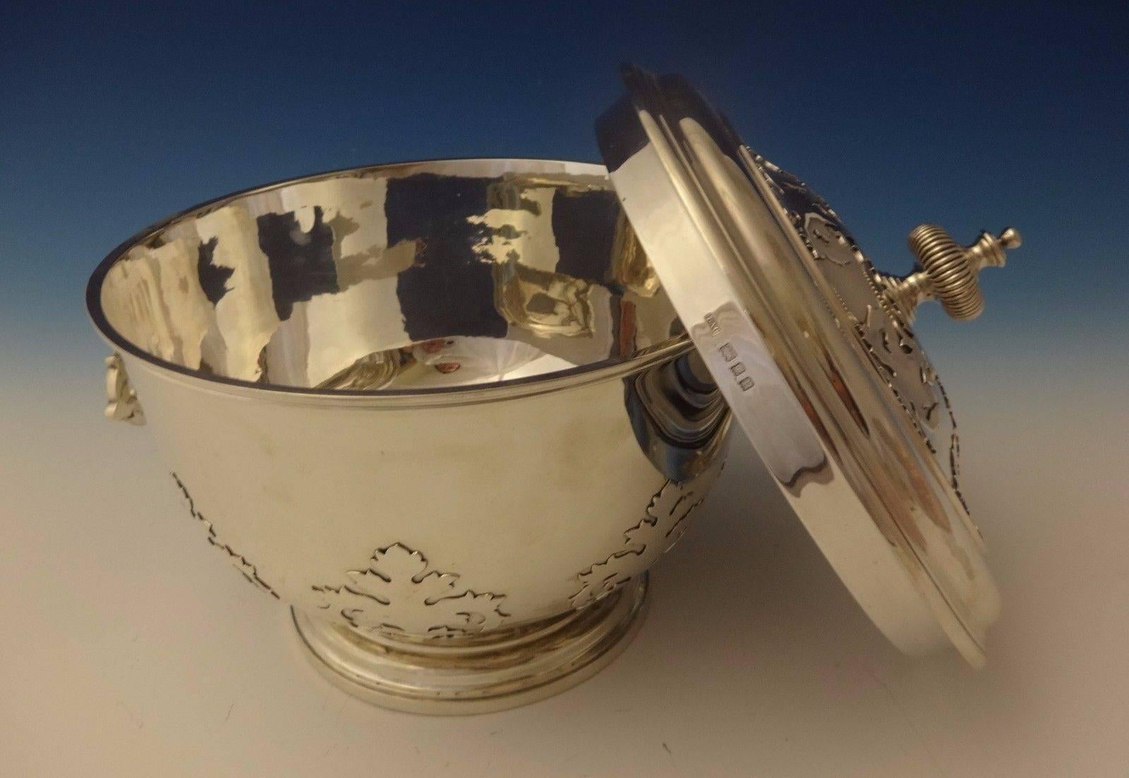 Crichton.

This exquisite sterling ice bucket was made by Crichton. It features an applied Arts & Crafts design. It has hinged handles and matching cover. The piece was made in London with date mark for 1930. Lionel Crichton and his brother