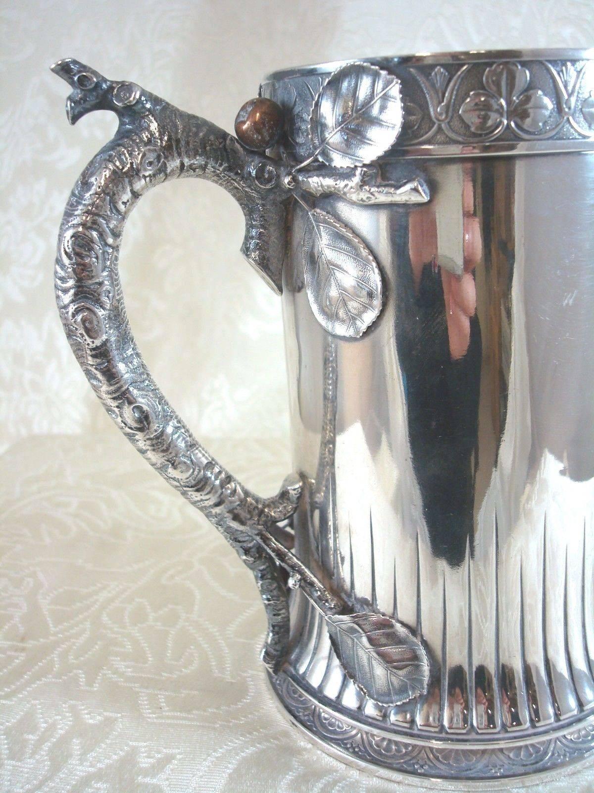 Mixed metals by Gorham.

Antique sterling silver mixed metals by Gorham tankard pitcher #d25 with realistic figural branch and leaf design and sterling, circa 1880s. The branch, leaf, and berry detailing is superb. It measures 6 1/8