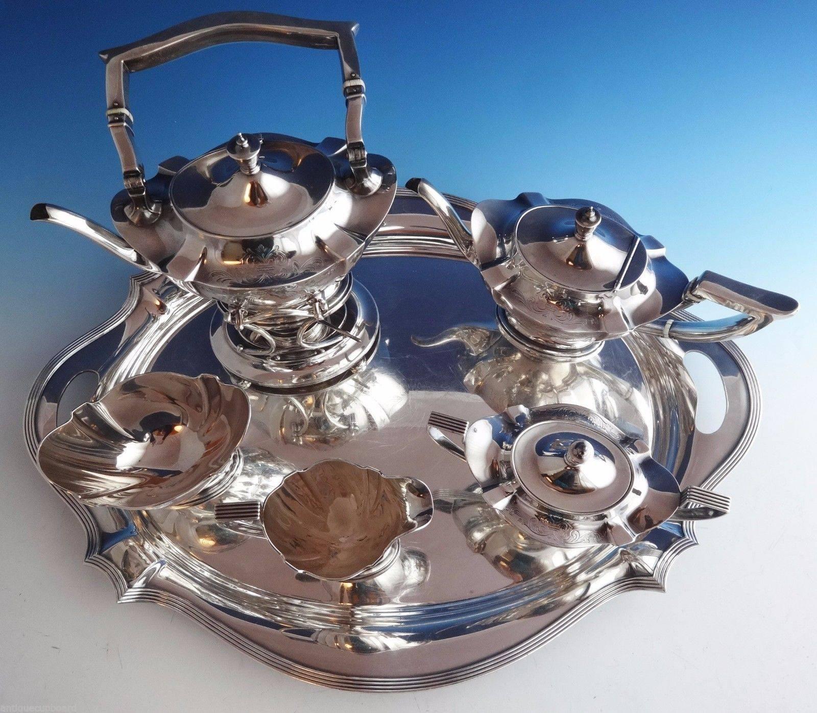 Plymouth Engraved by Gorham.

Impressive plymouth engraved by Gorham sterling silver five-piece tea set with silver plate tray. It features beautiful engraved scrollwork. The set includes:

Kettle on stand: Marked with #A2446, holds 2 3/4 pints, and