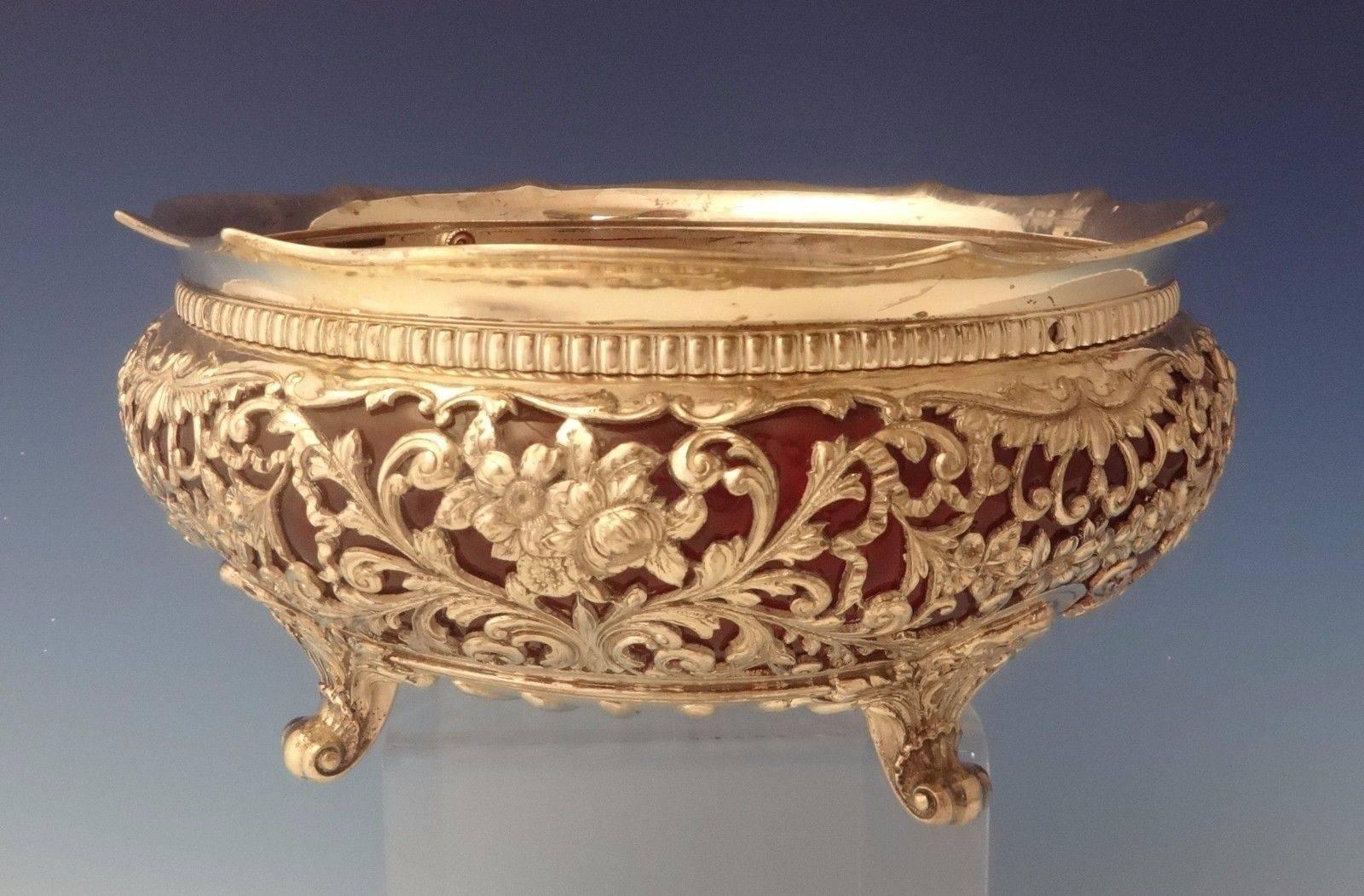 Gorham.
A Gorham sterling pierced centerpiece bowl with beautiful hand engraved flowers and leaves. It has the original gorgeous handblown ruby glass liner. The bowl is footed and marked with #S1216. It dates from 1892. The measurements for the