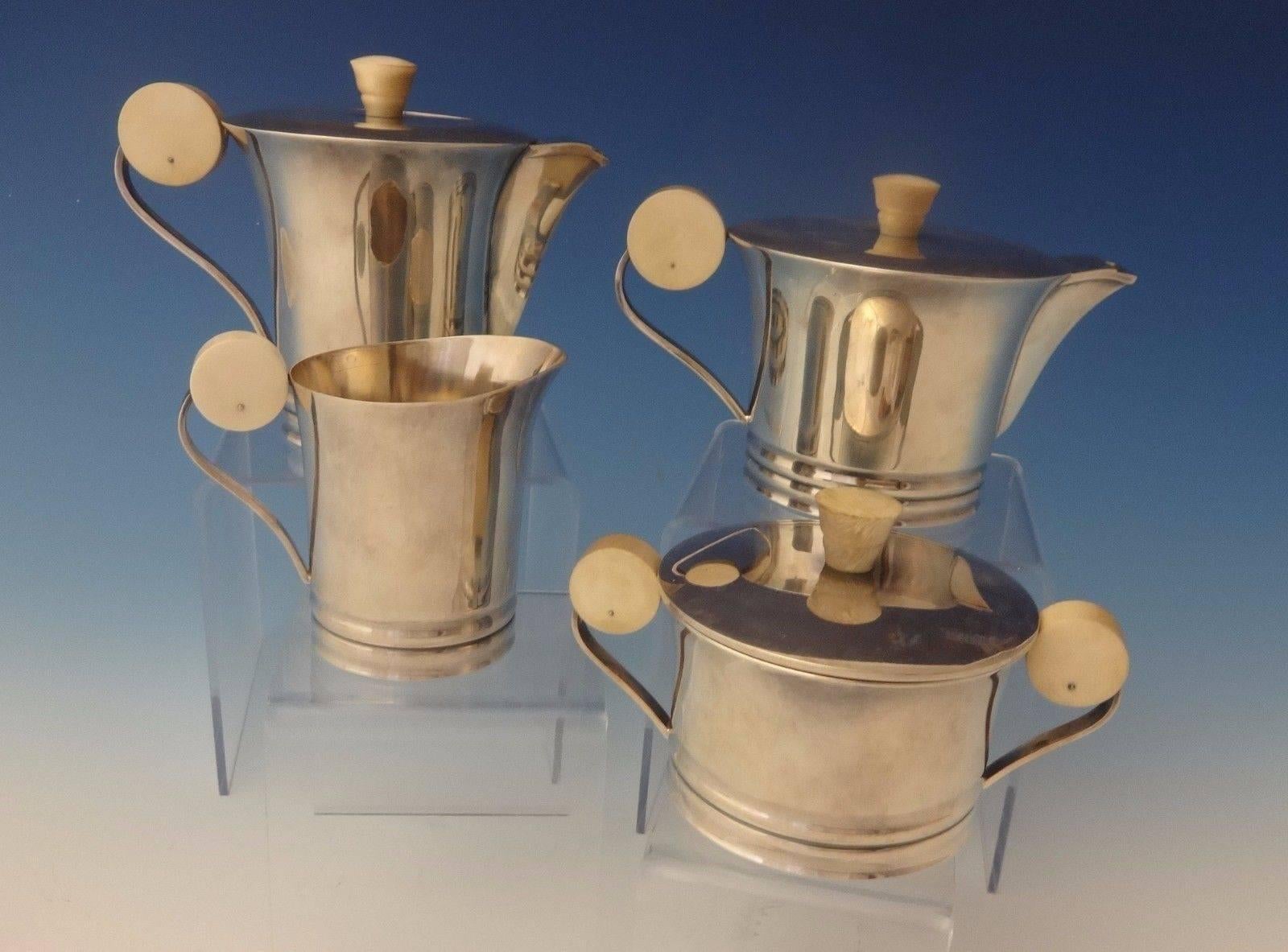 French .950 sterling silver. 

Art Deco French sterling petite individual tea set with finials and distinctive large round accents on the handles. The set dates from 1915-1930's. The maker is unknown. The set includes:

Coffee pot: Measures 4 1/2