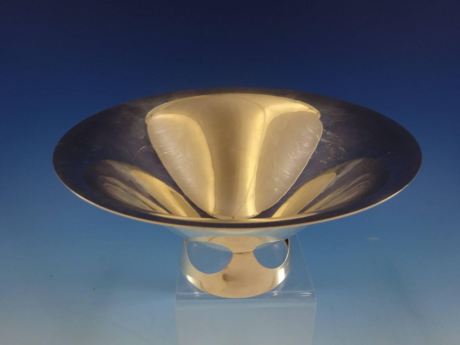 S. Kirk & Son.

Unusual S. Kirk & Son sterling silver Mid-Century Modern fruit bowl. The conical bowl has a slightly averted rim and sits on a unique, round, pierced base. Height 4 3/8