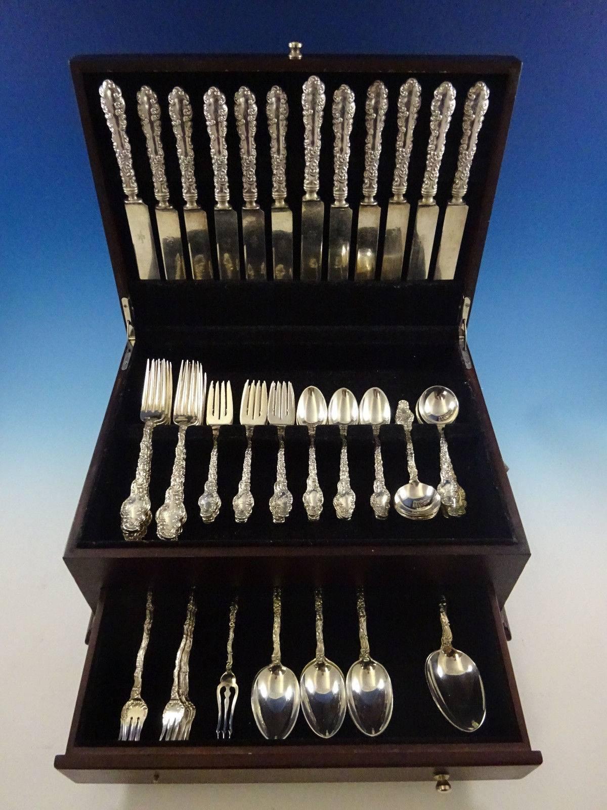 Watteau by Durgin sterling silver dinner size flatware set - 86 pieces. 

This set includes:

12 Dinner knives, blunt silver plated blades, 9 5/8