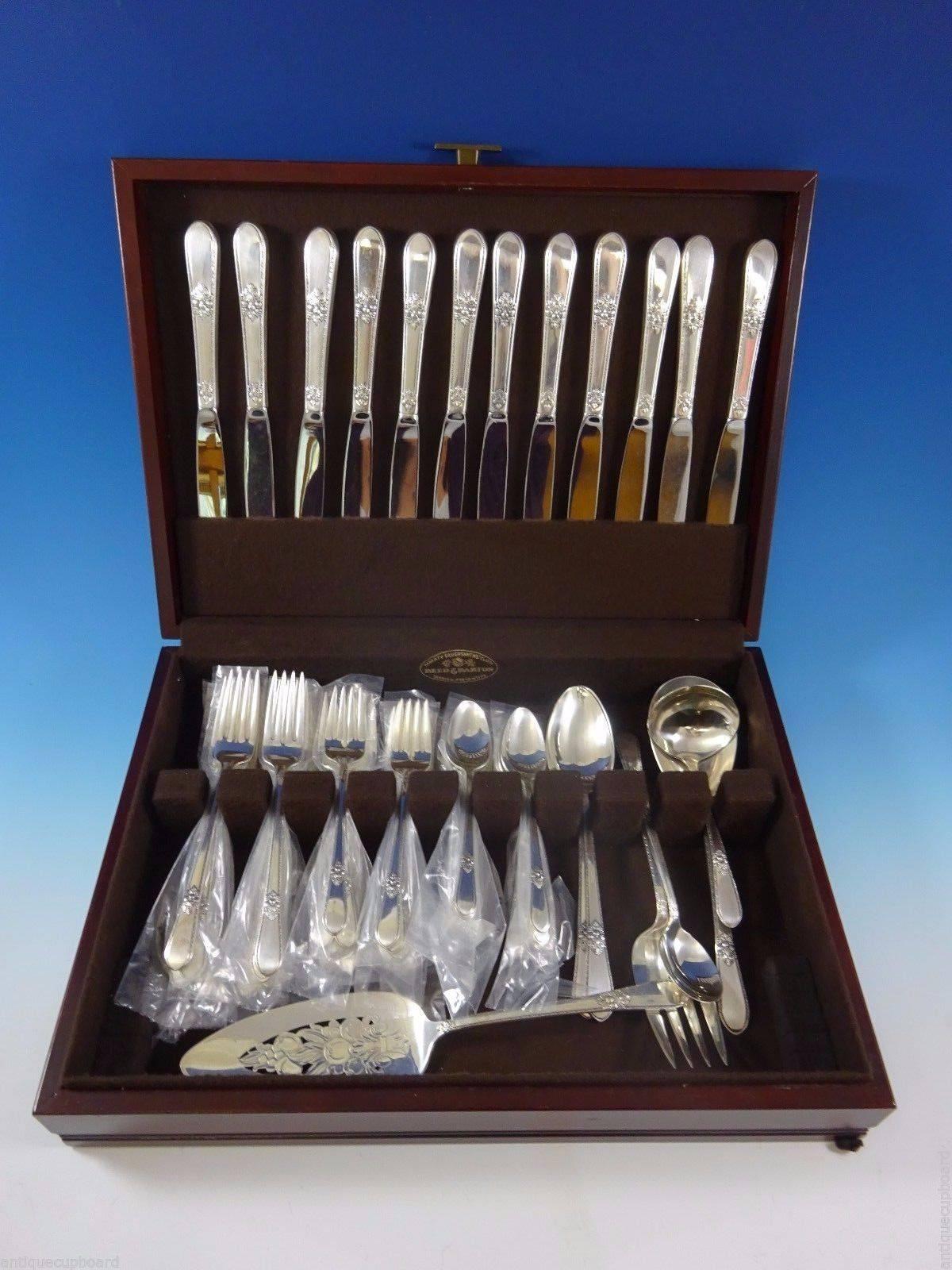 12 dinner knives 9 3/8", 12 dinner forks 7 5/8", 12 salad forks 6 3/4", 12 teaspoons 6 1/8", one gravy ladle 6", two serving spoon 8 1/2", one cold meat fork 9", one pie server 10 1/2", one berry spoon