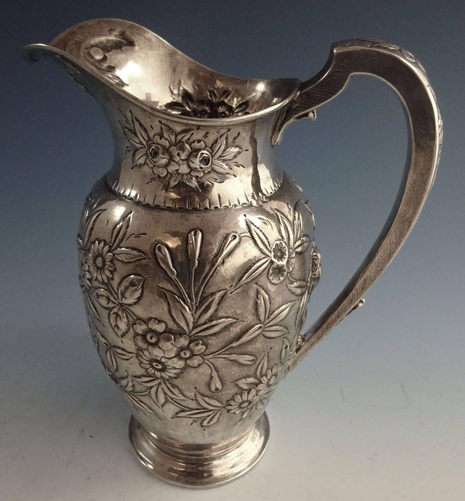 Repousse by Kirk sterling silver water pitcher. The piece is monogrammed near the base (see photo). It's marked with #184F with hallmarks dating from 1896-1924. The pitcher measures 10 1/8" x 7 1/2" and it weighs 22.07 ozt. It is in
