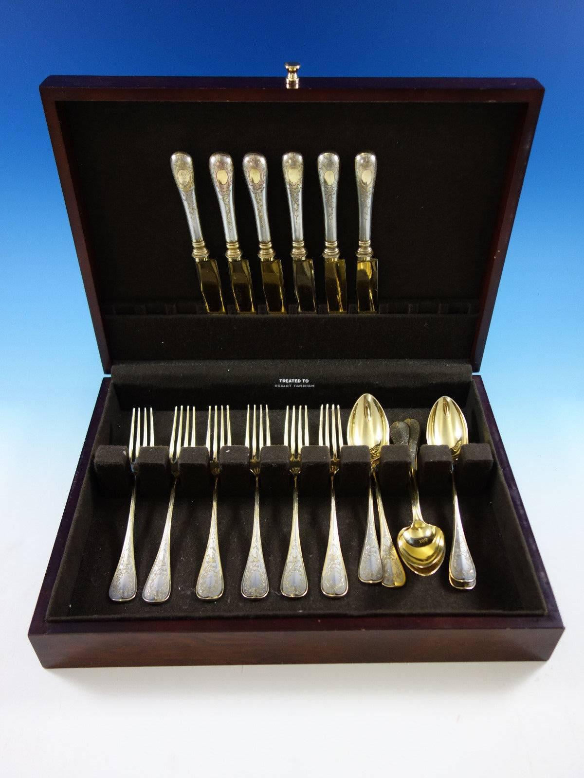 Unusual partial-gilt German 800 silver dessert set with bird, wreath and bow motif 18 pieces. This set includes:

Six dessert knives, 8 1/4