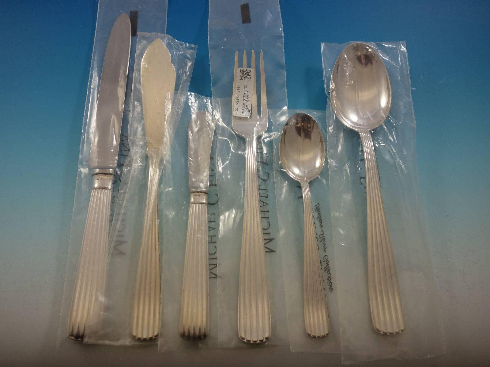 America by Schiavon, retailed by Michael C Fina, Italian sterling silver flatware set of 42 pieces. This set is in pristine, unused condition with most of the pieces still in the factory sleeves. This set includes: 

Six dinner size knives, 9 3/4