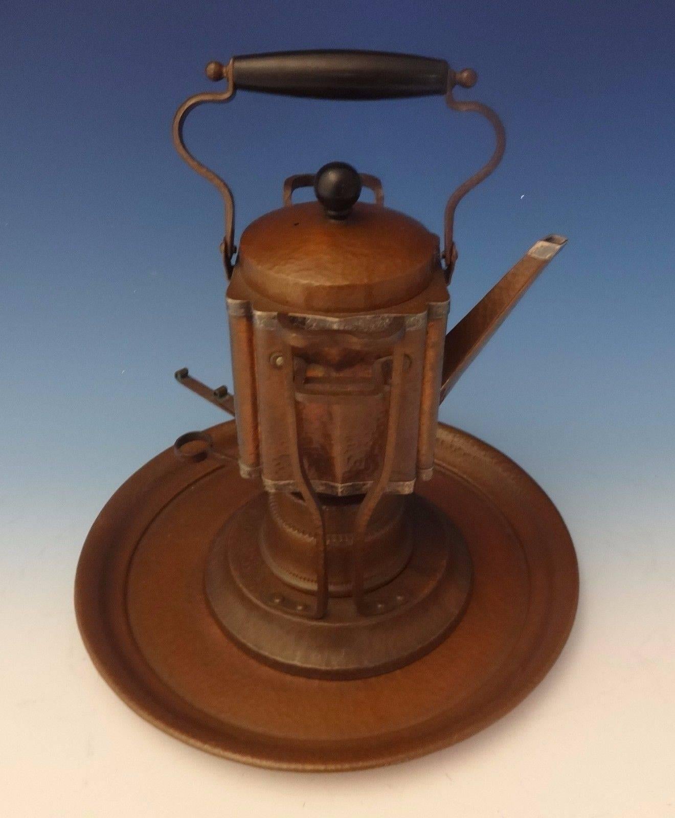 Joseph Heinrichs: Arts & Crafts kettle on stand and tray was handmade by Joseph Heinrichs. The piece is made of copper and with applied sterling silver, it's hand-hammered, and it dates from about 1905. The measurements for the piece are 13