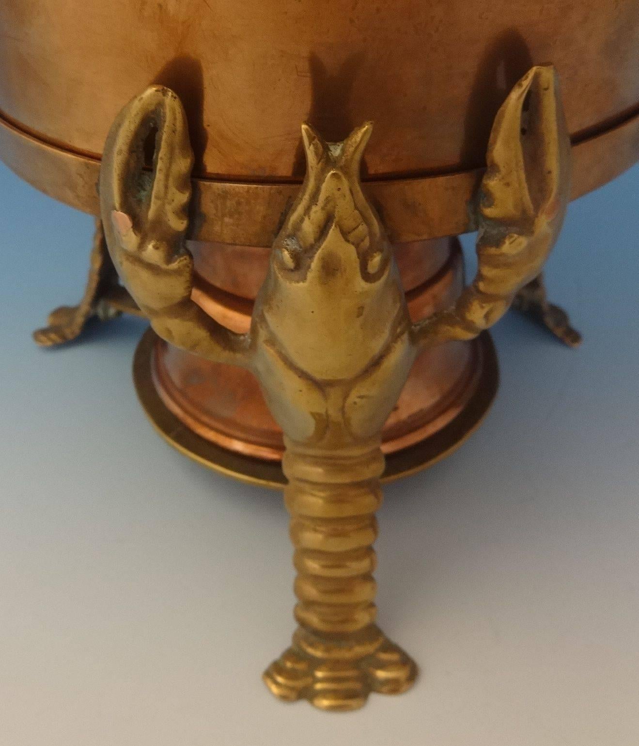 Joseph Heinrichs: This impressive copper and brass lobster pot was made by Joseph Heinrichs. The piece has 3-D lobsters and it dates from circa 1905. It is made of bronze lobsters and a copper and sterling pot. The measurements for the pot are 9